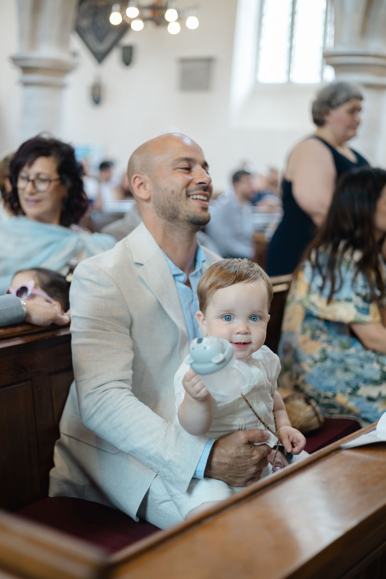A heartwarming moment in a church pew as attendees smile during a service.