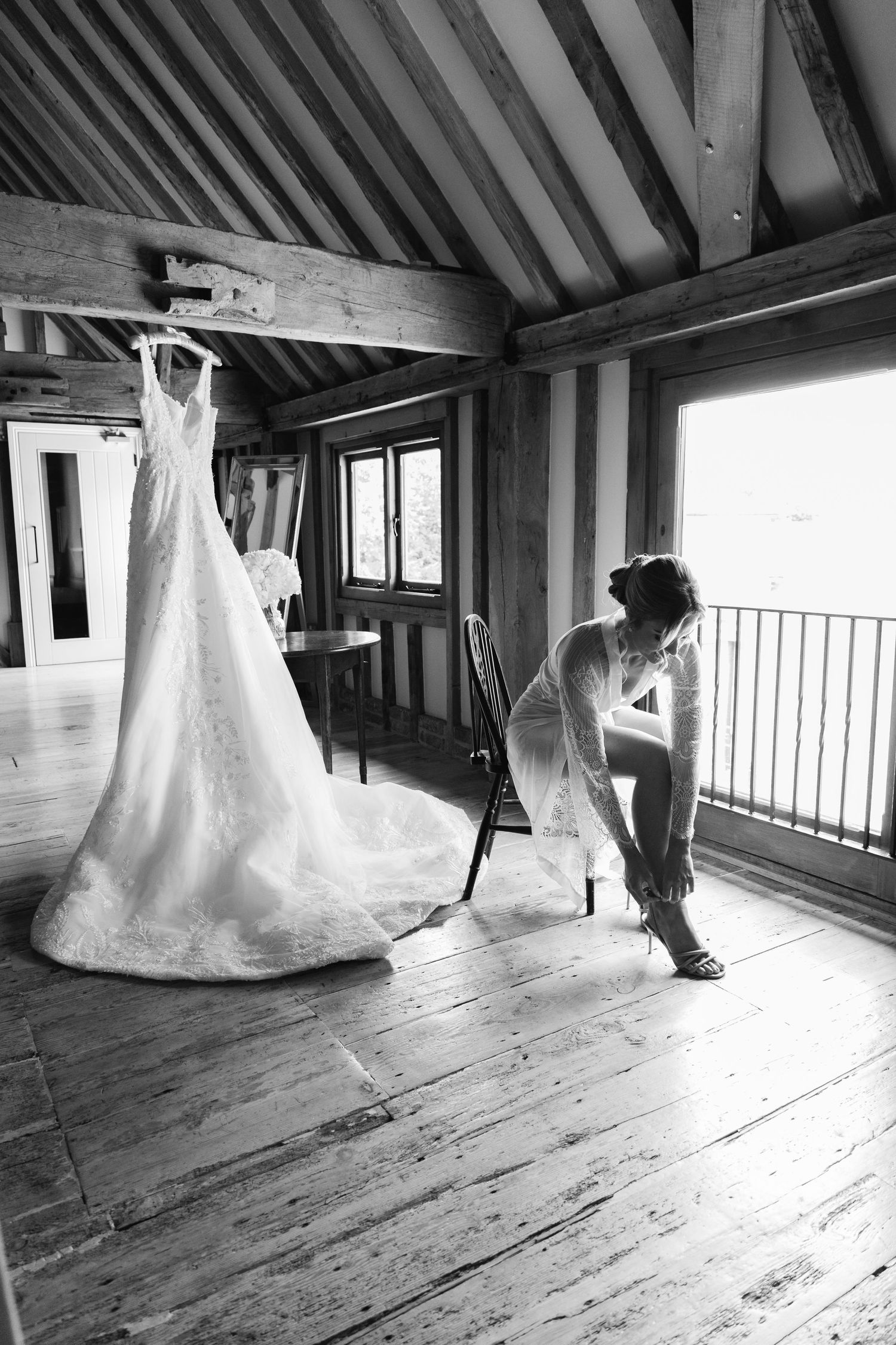 Black and white series showing wedding dress movement in rustic wooden attic space.