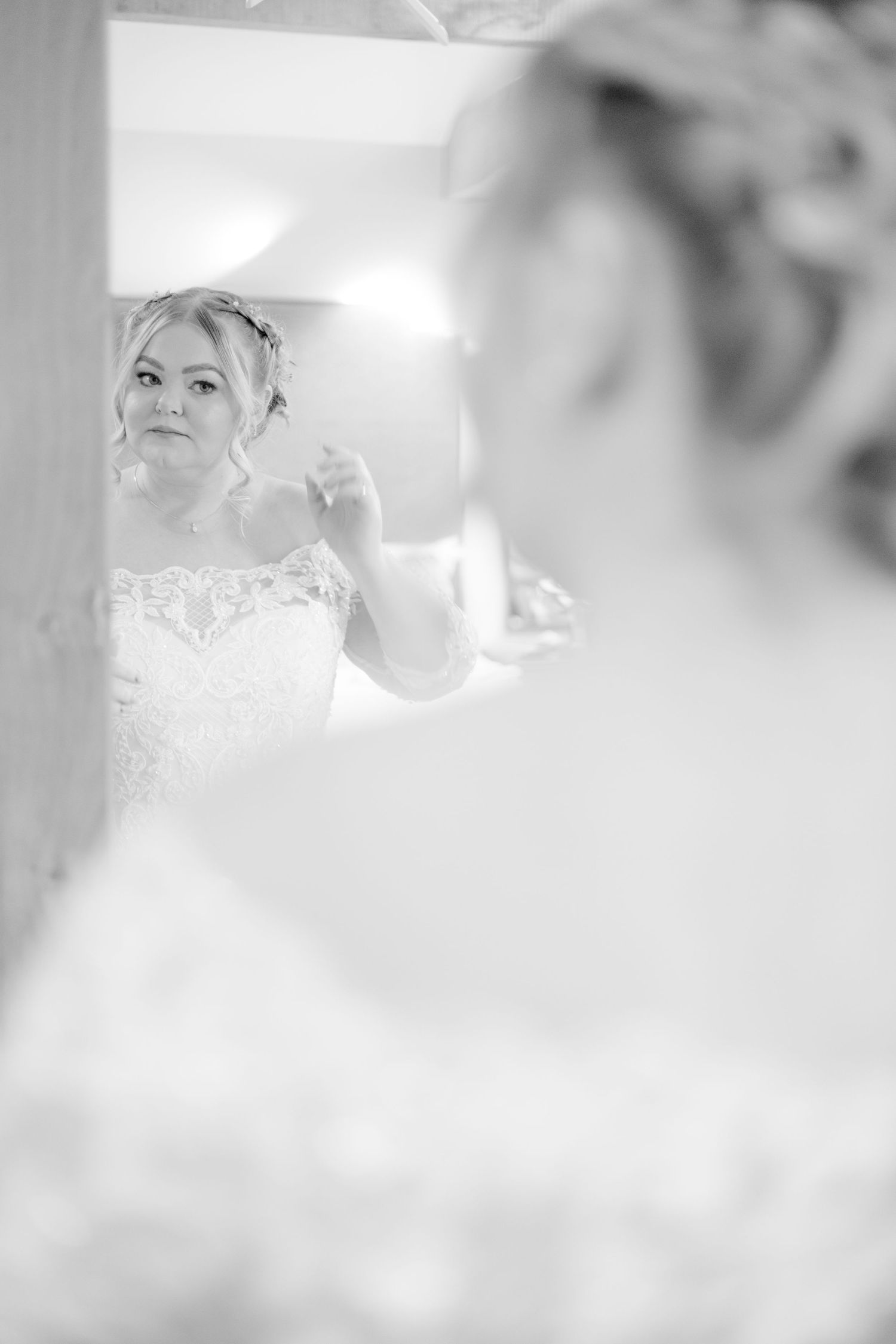 Soft focus black and white wedding portraits with delicate lace details.
