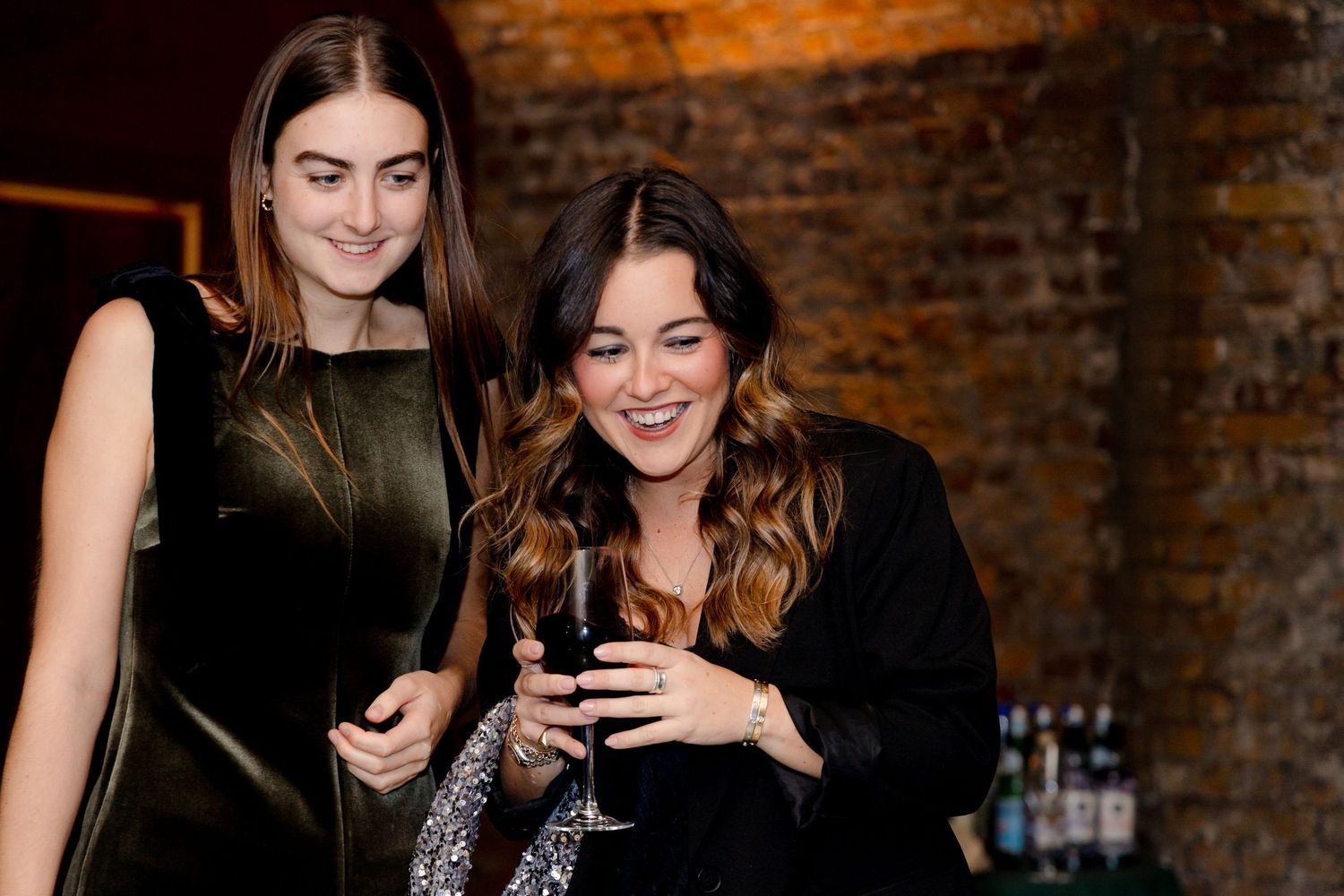 Friends socializing and taking photos at an evening party.