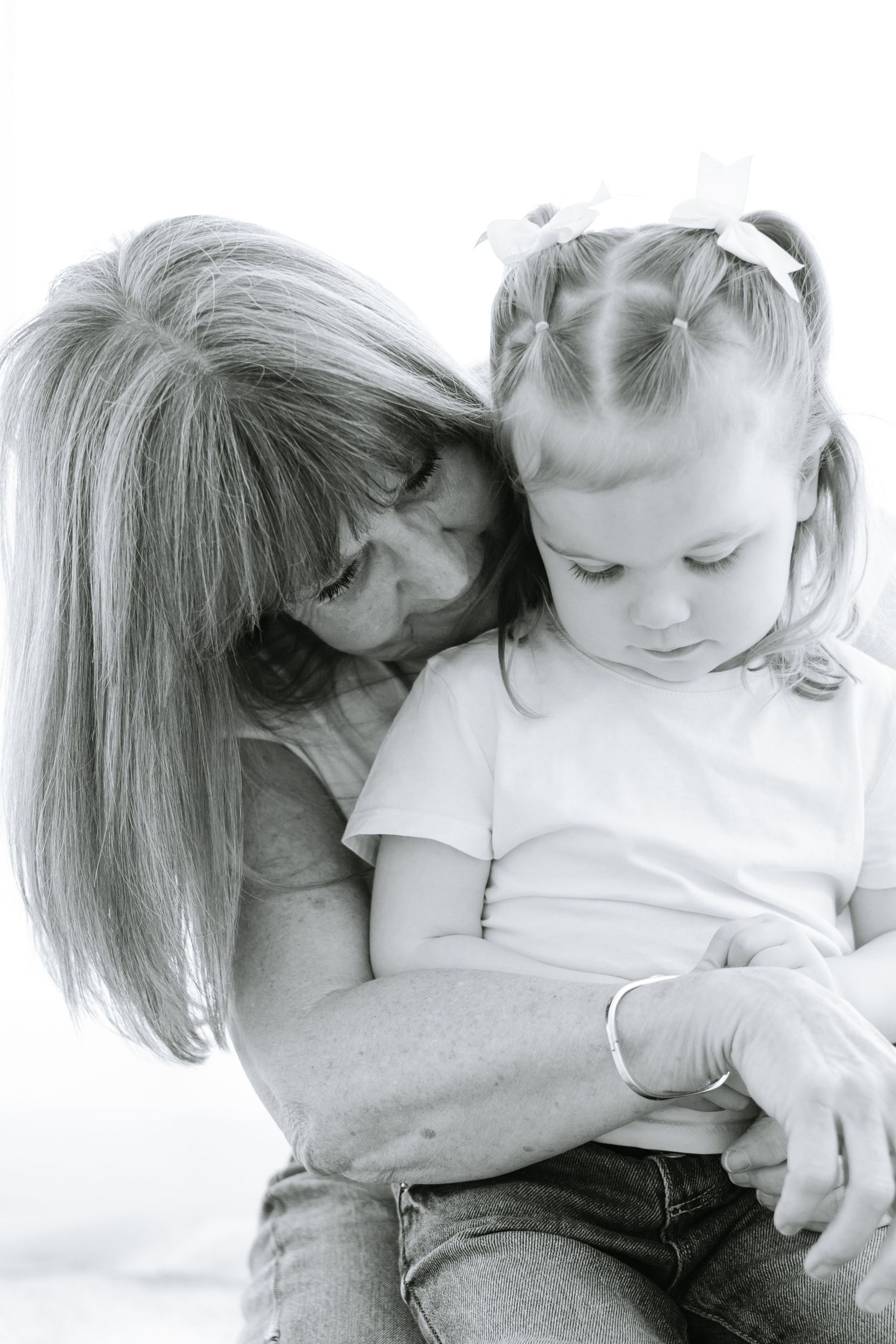Black and white series showing tender family moments of embracing and cuddling.