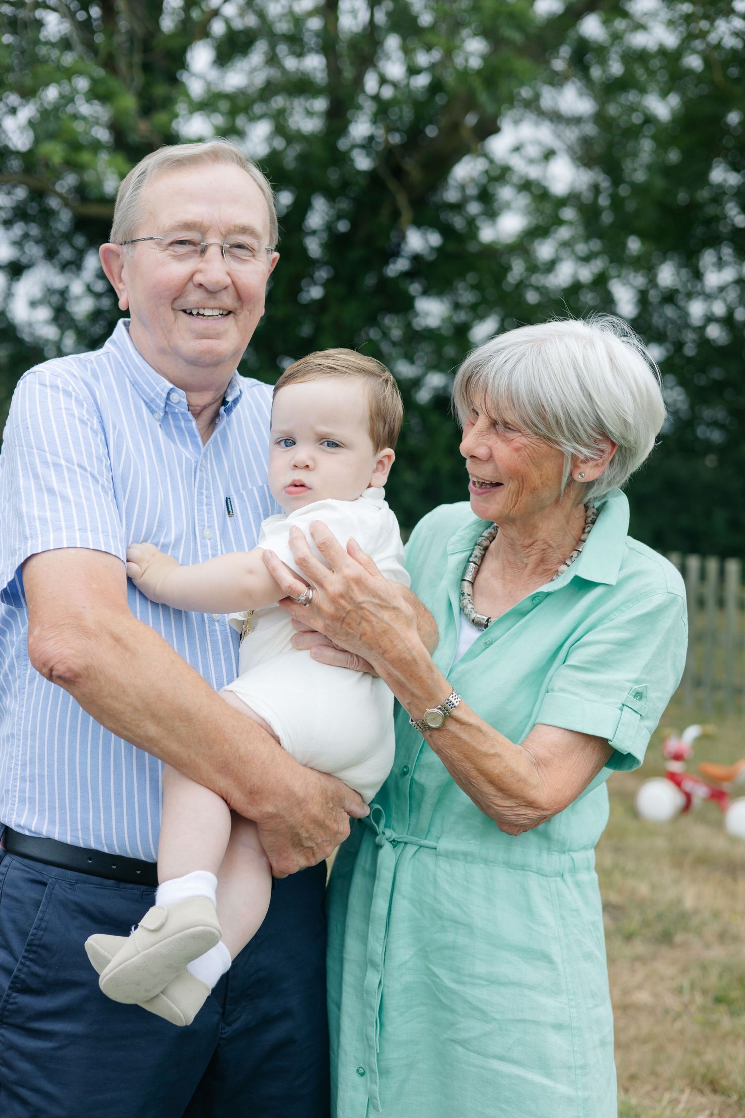 Family members share joyful moments together in a casual outdoor setting.