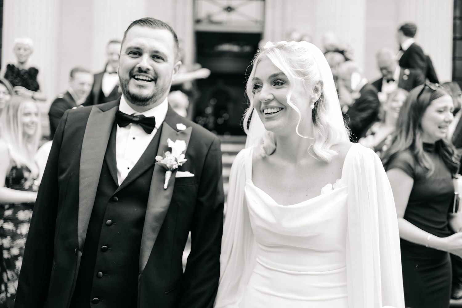 Black and white candid shots of wedding couple sharing joyful moments.