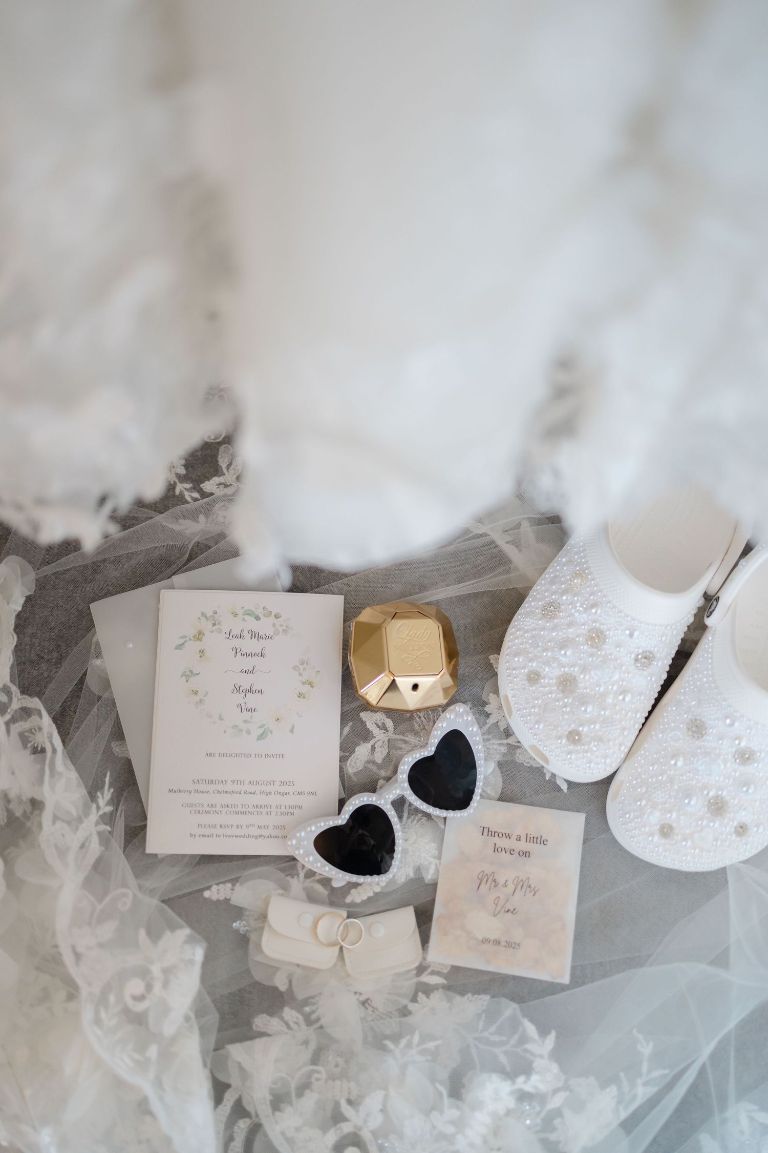Wedding invitation suite and stationery details in soft pink and white tones with lace accents.