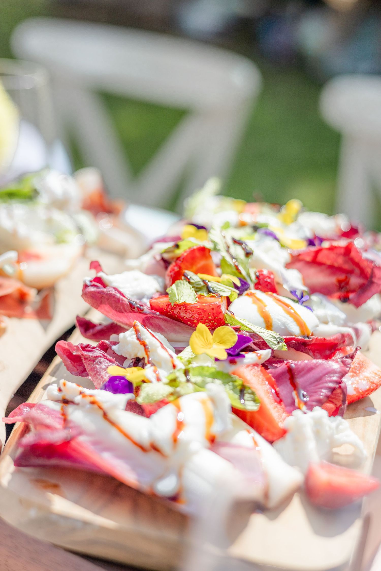 Colorful appetizer plates garnished with edible flowers and microgreens.