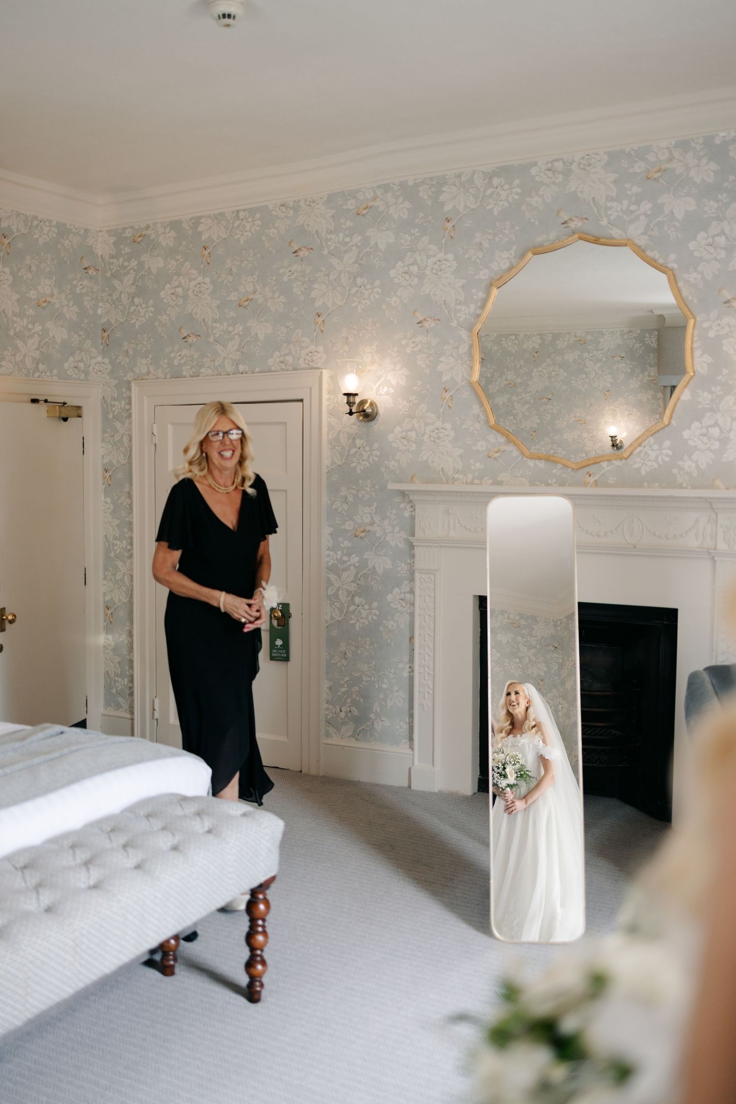 Elegant bridal preparation room with floral wallpaper and white furnishings captured in a sequence of getting ready moments.