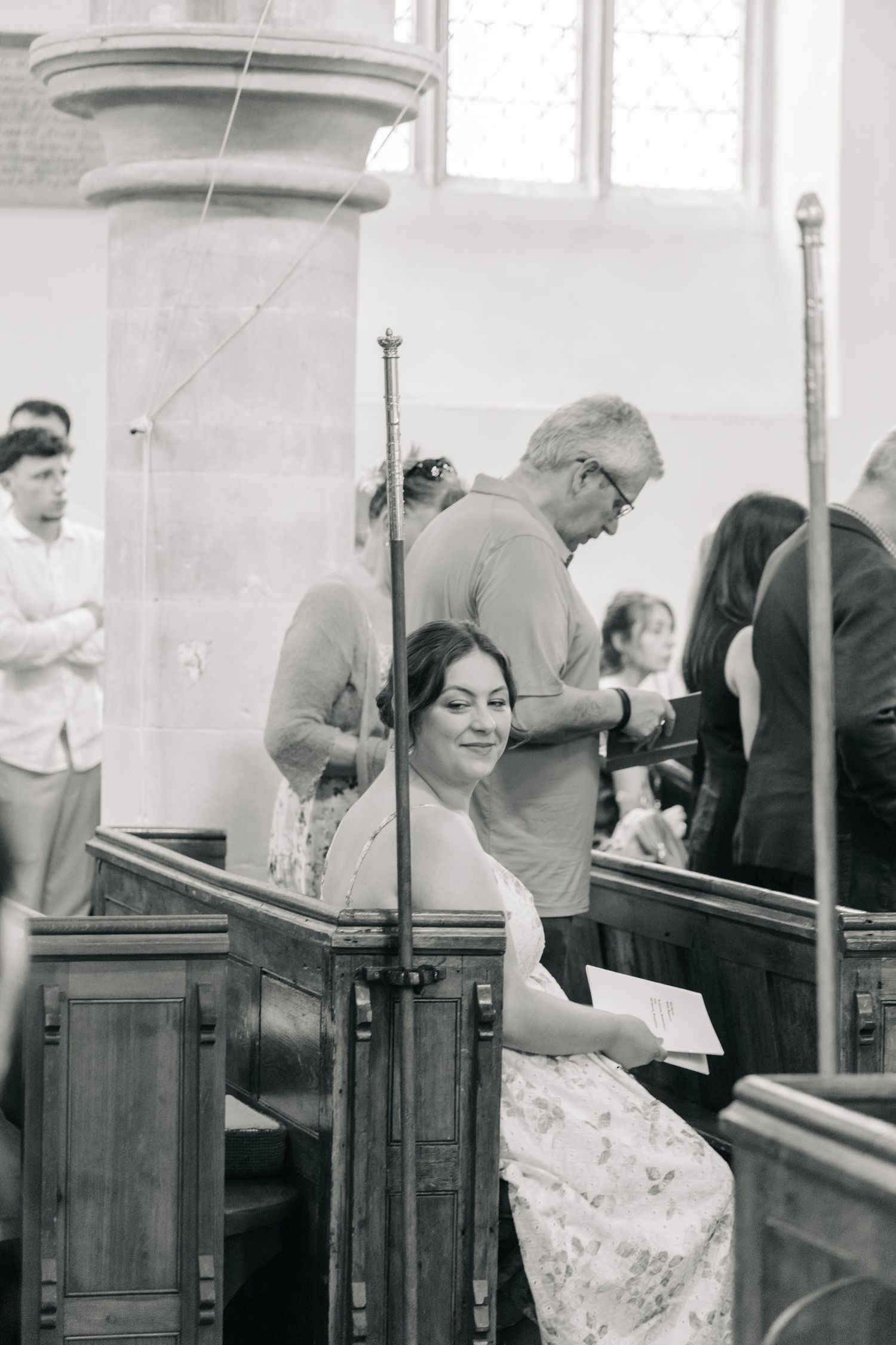 A black and white photo capturing a candid moment during a church service.