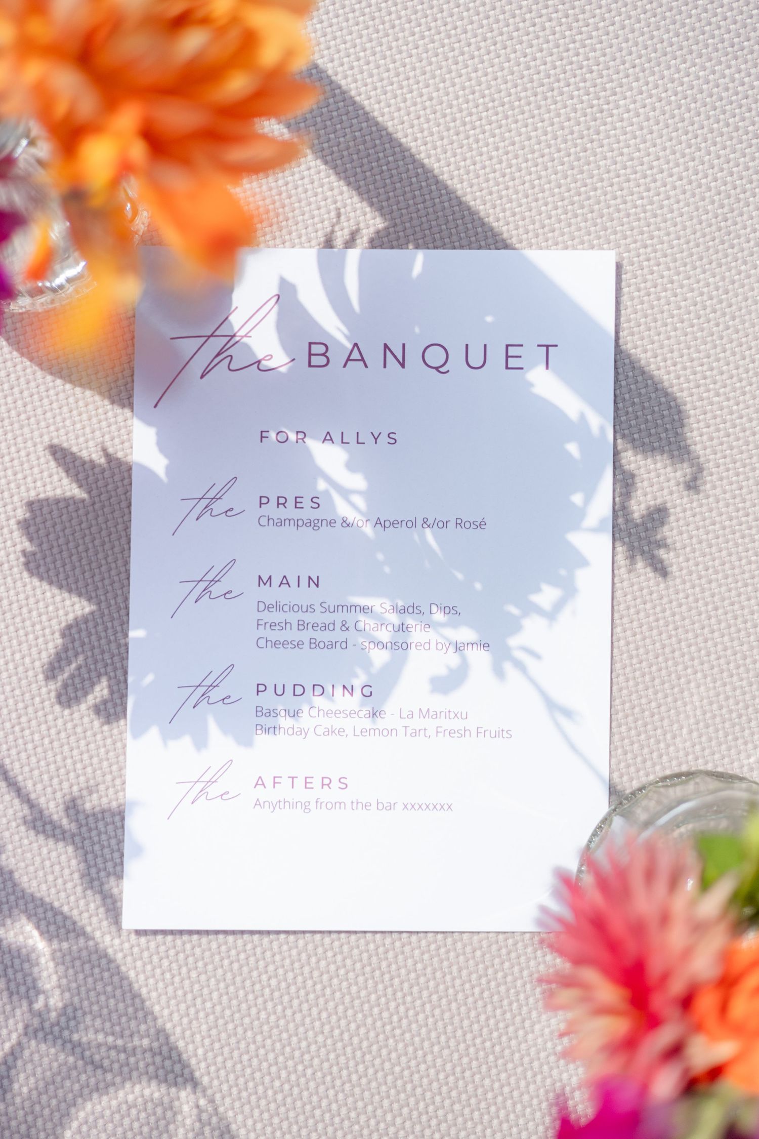 Elegant wedding menu cards with floral decorations displayed against a light textured background.
