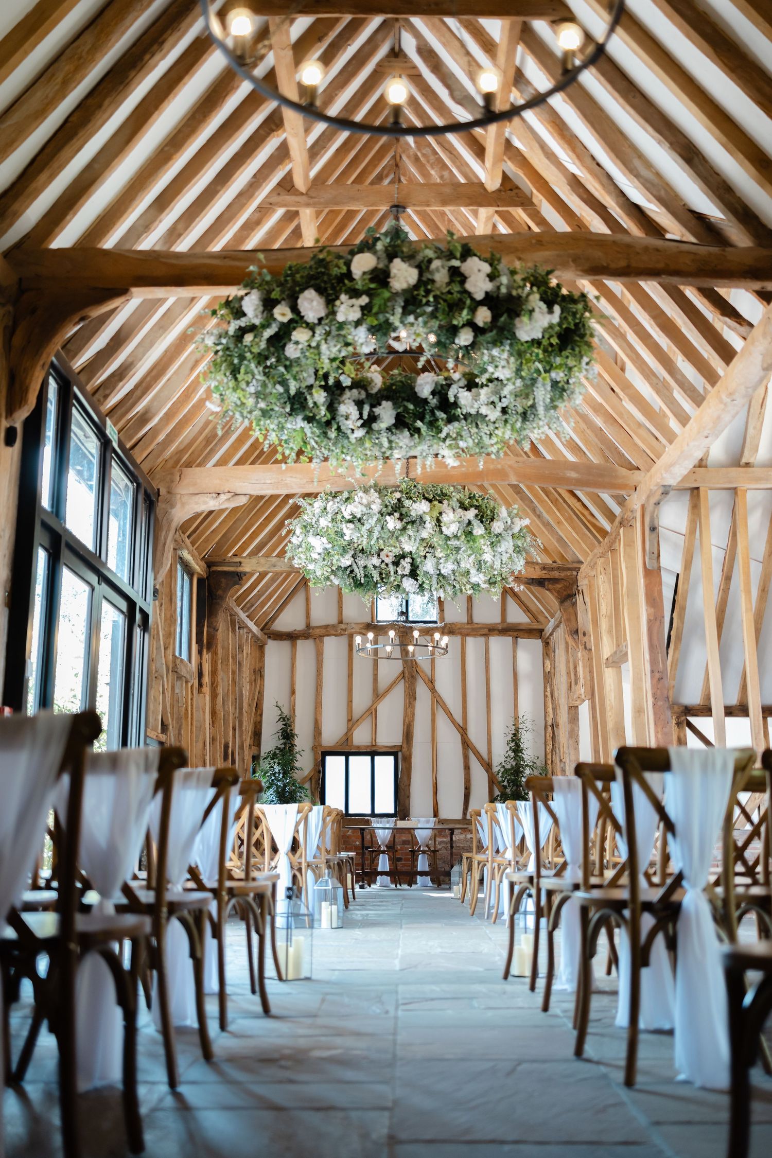 Wedding reception celebration with guests seated at tables in an industrial-style venue.