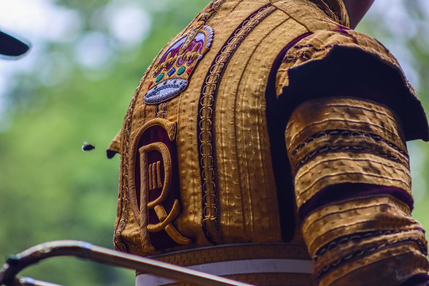 Ornate gold military uniform details shown in close-up segments.