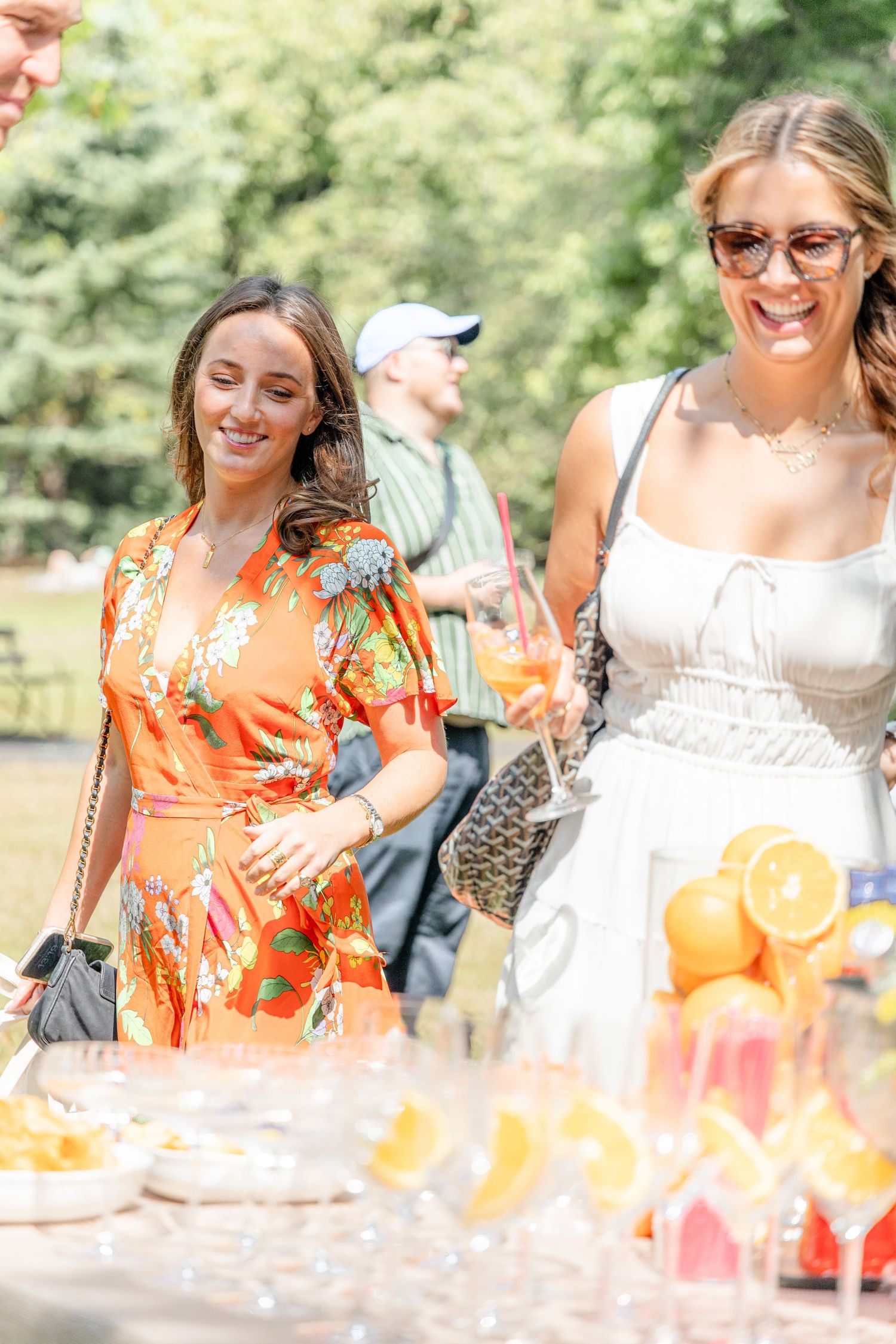 Festive outdoor celebration with colorful drinks and summer attire.