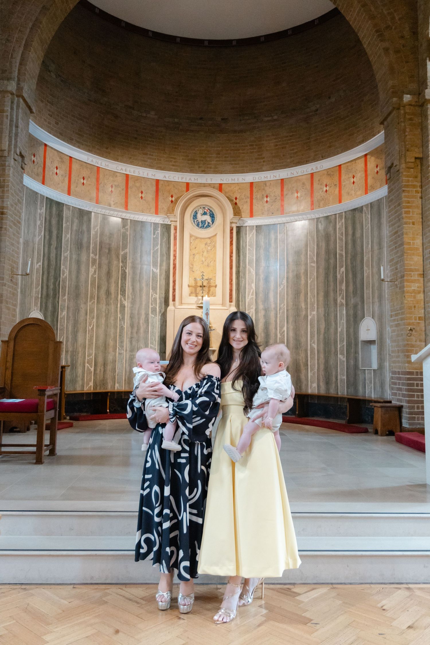 Group photo in a circular church room with brick walls and decorative ceiling.
