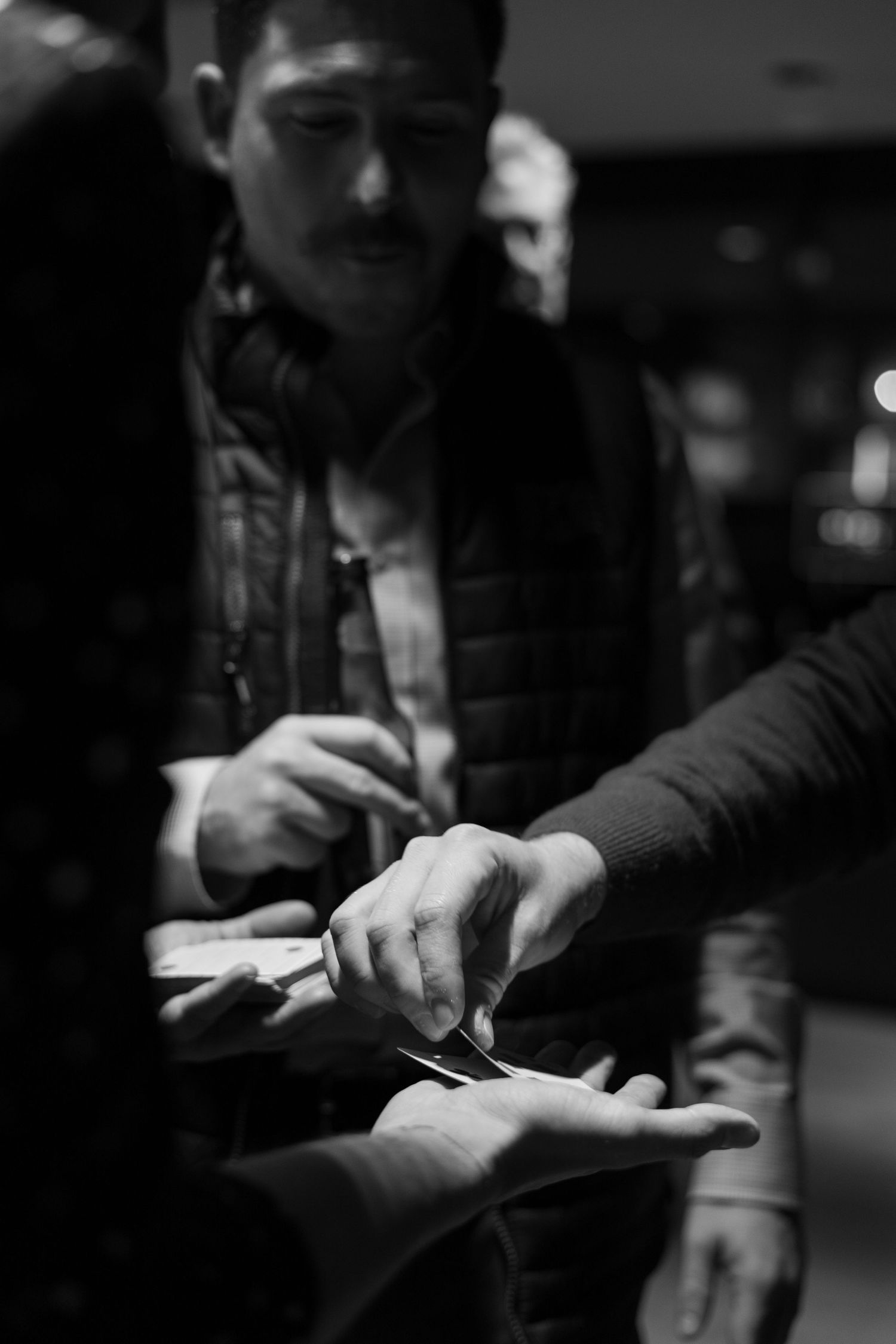 Close-up shot of hands gesturing during a conversation in dim lighting.