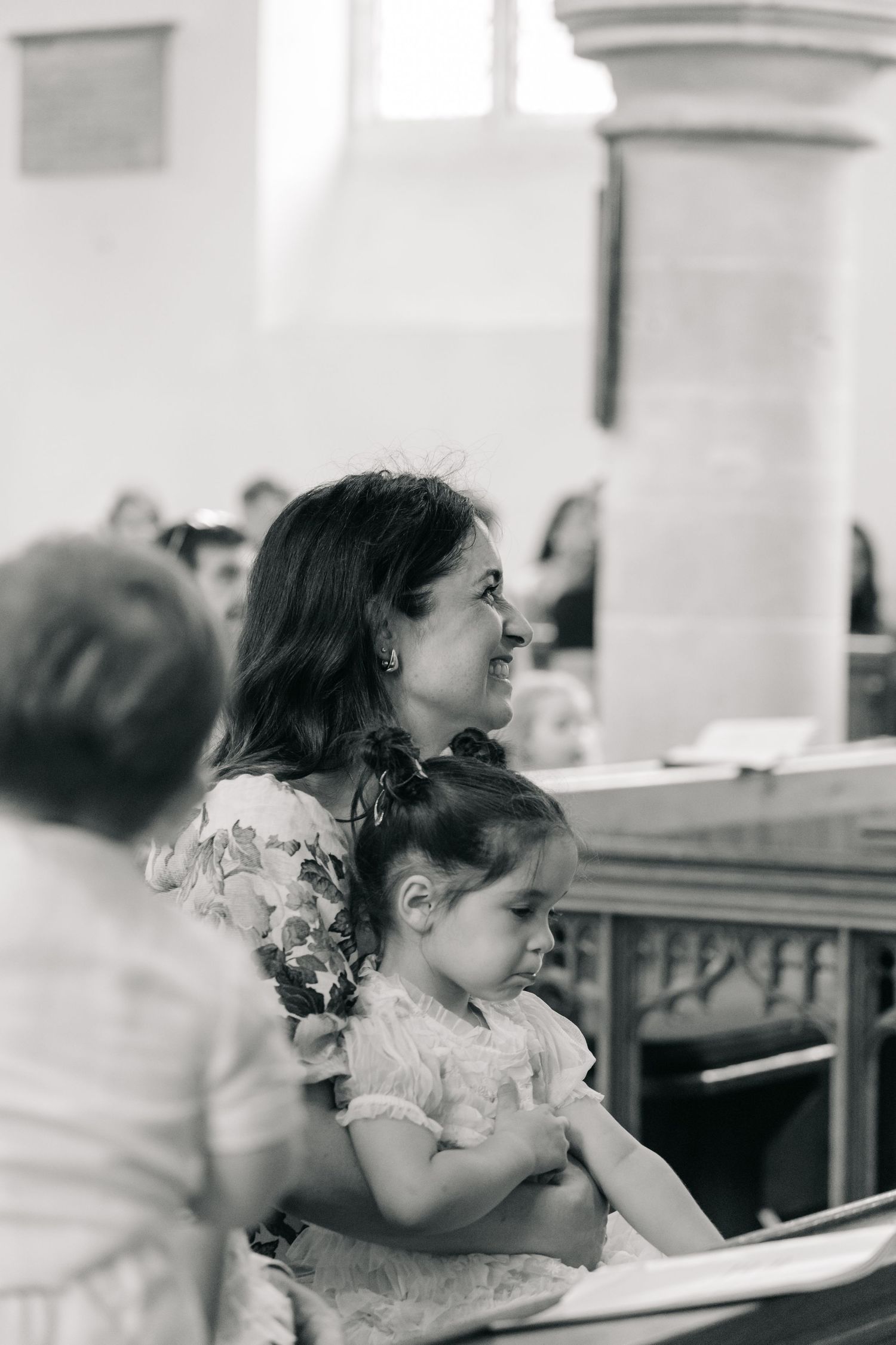 Black and white photo of attendees sitting in church pews.