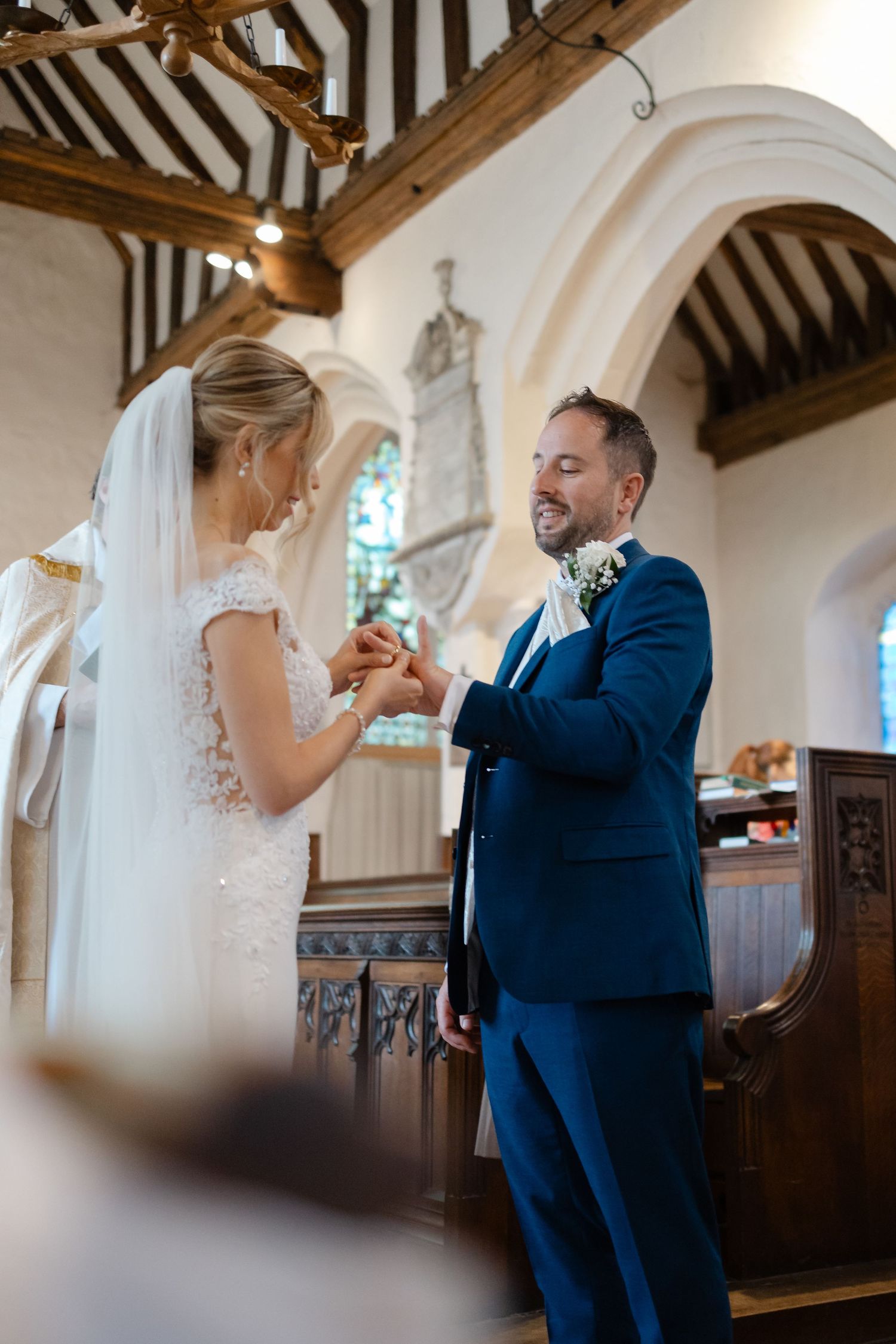 Couple dancing and laughing together inside a historic church with wooden beams.