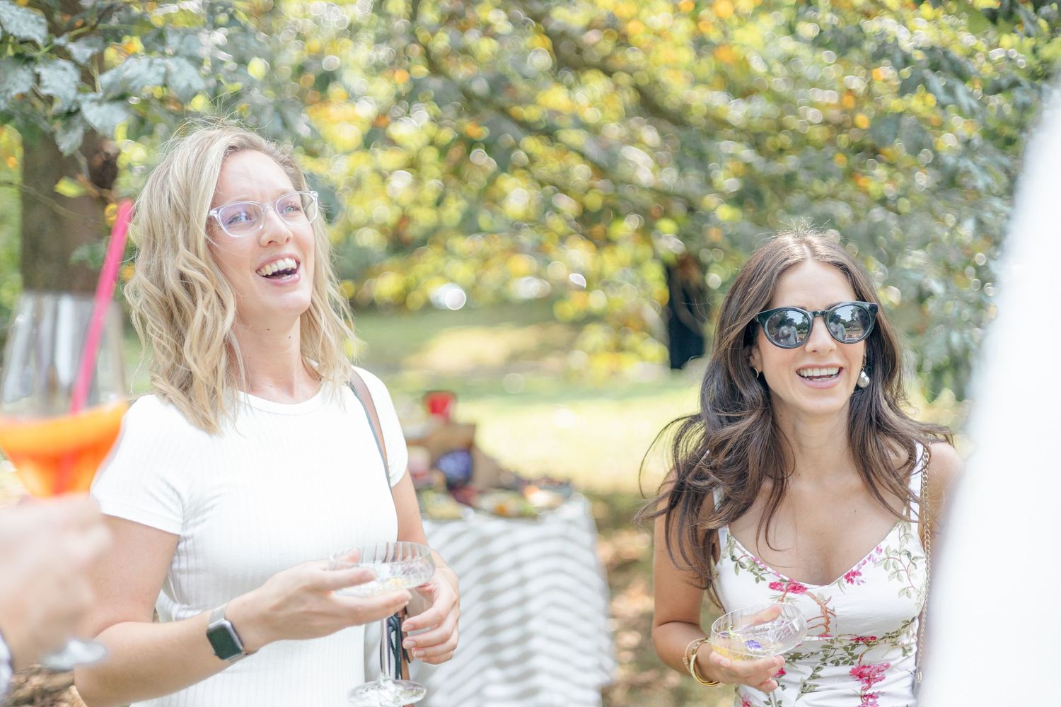 Guests sharing joyful moments at an elegant outdoor celebration.