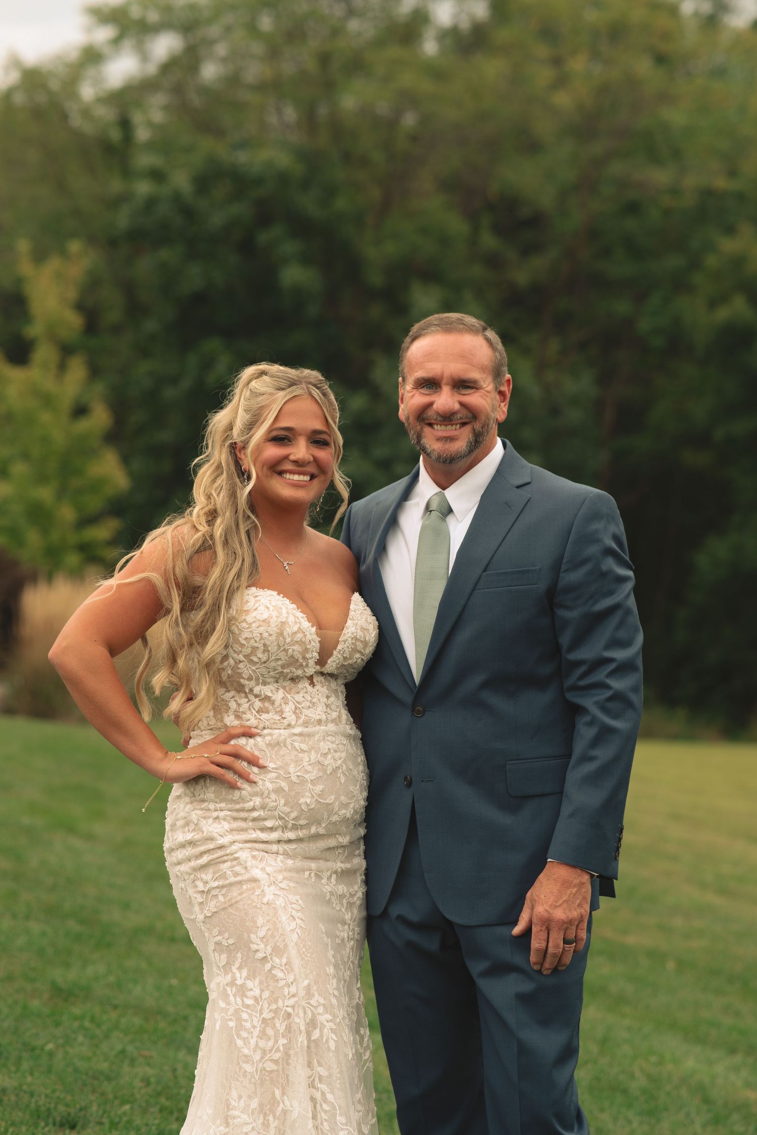 Outdoor wedding portraits on a grassy lawn with couple in formal attire.