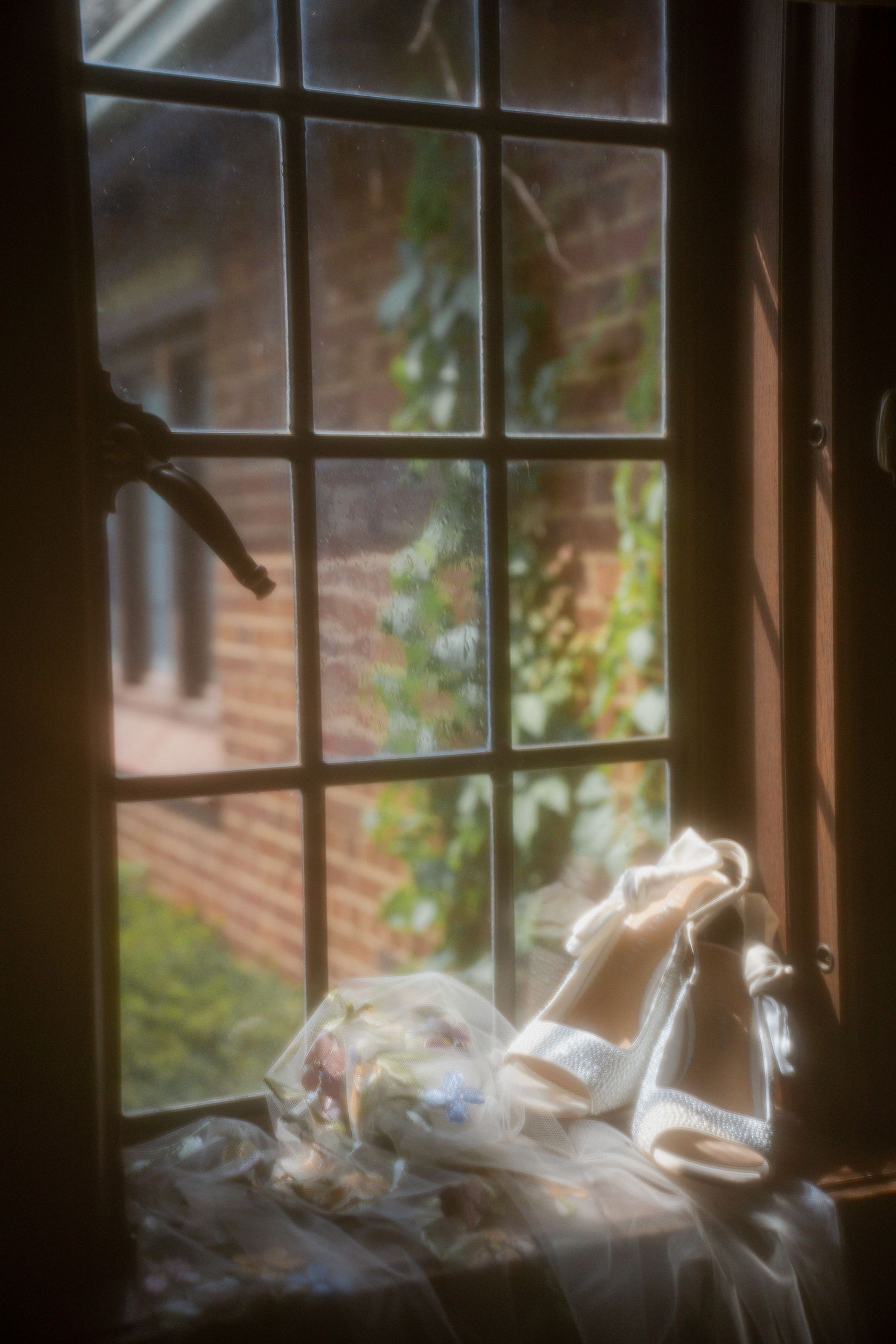 Atmospheric window scene with translucent smoke patterns floating in natural light.