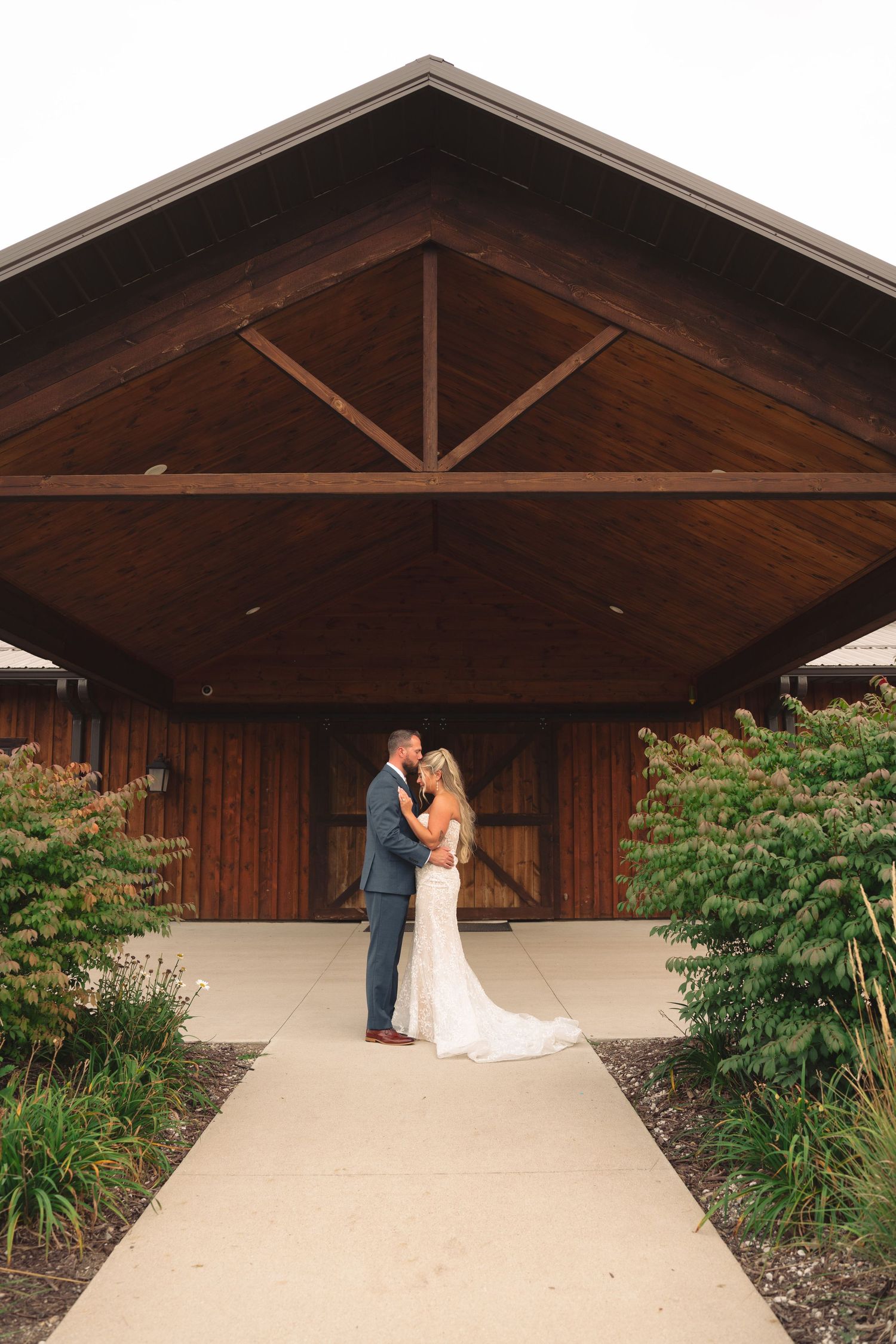 Elegant wooden pavilion decorated for outdoor wedding ceremony.