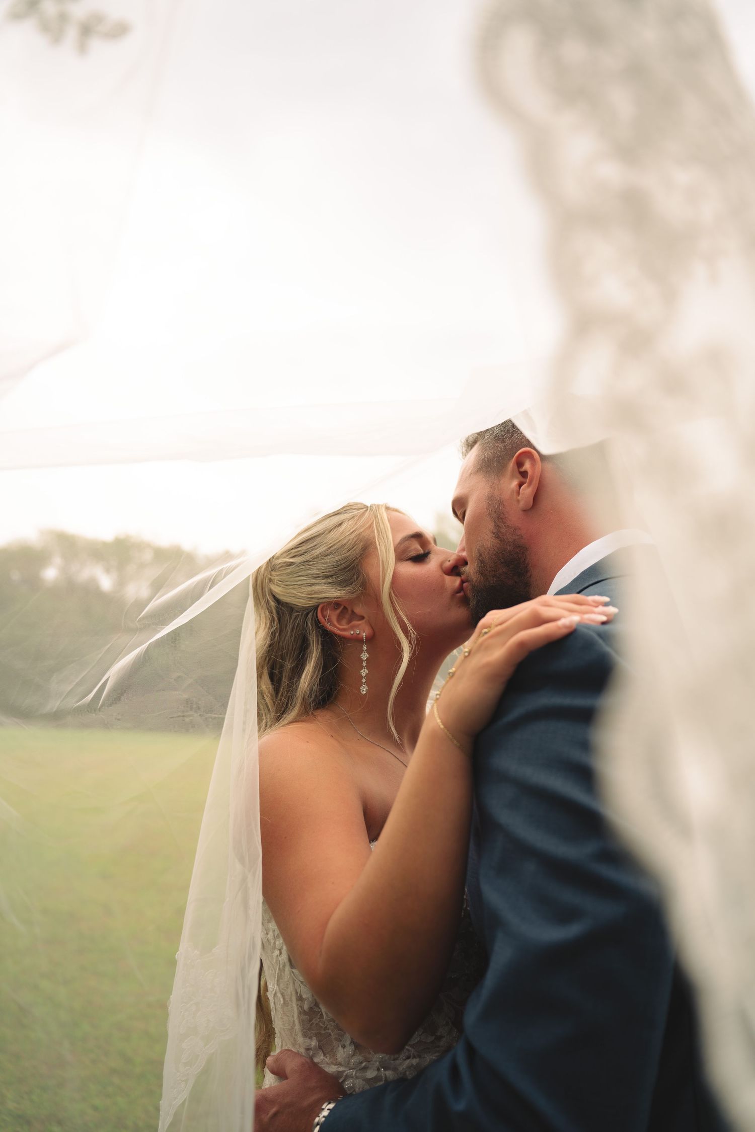Soft focus romantic wedding portraits capturing intimate moments between newlyweds.