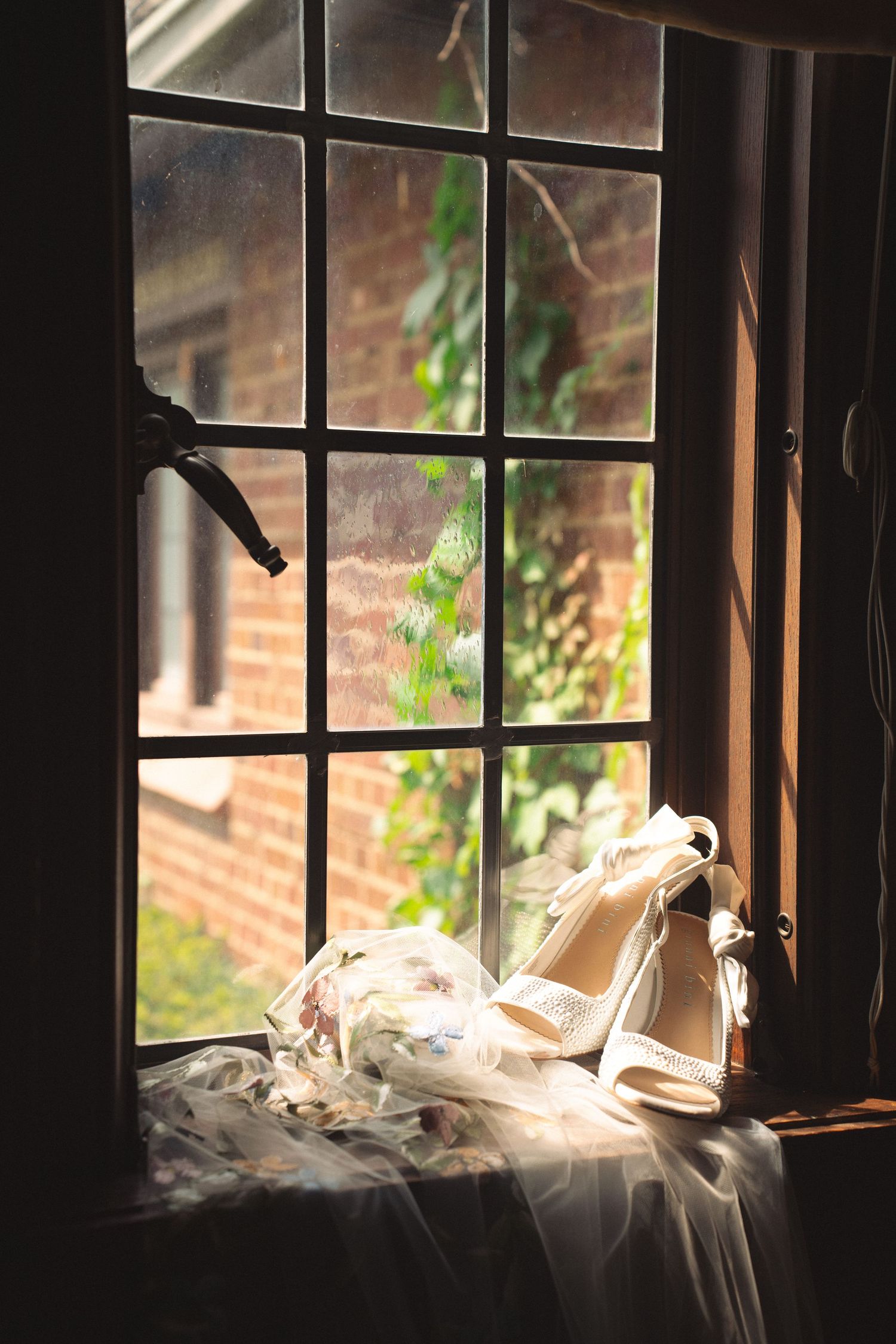Sunlit window view with wisps of smoke or vapor creating a dreamy atmospheric effect.