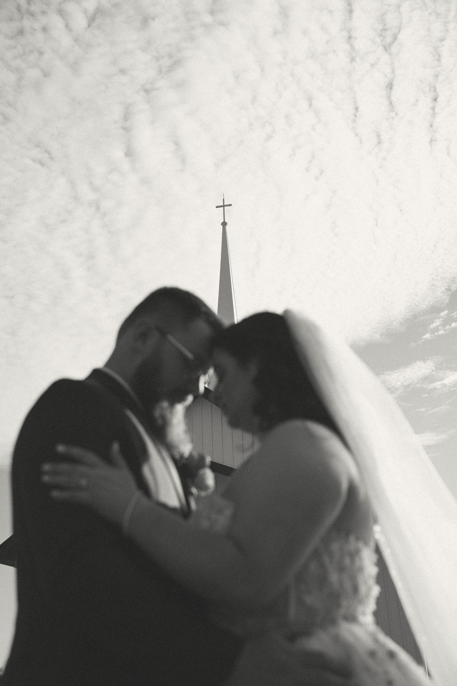 Black and white wedding photo with church steeples visible in the background.