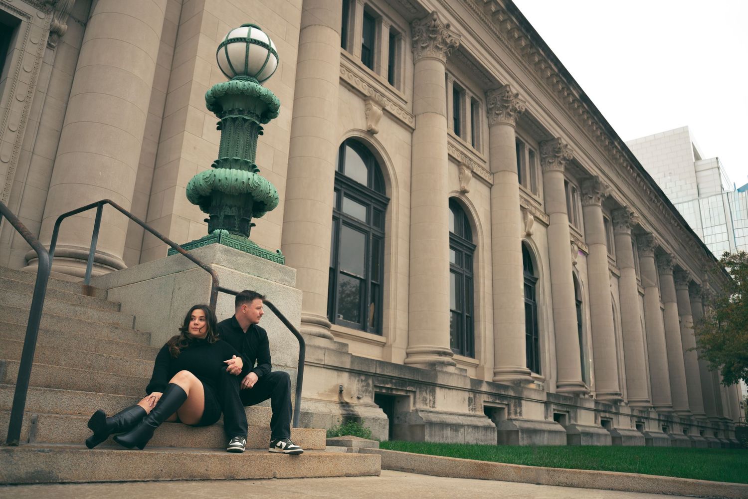 A panoramic collage of classical architecture columns and ornate green lamp posts along a grand building facade.