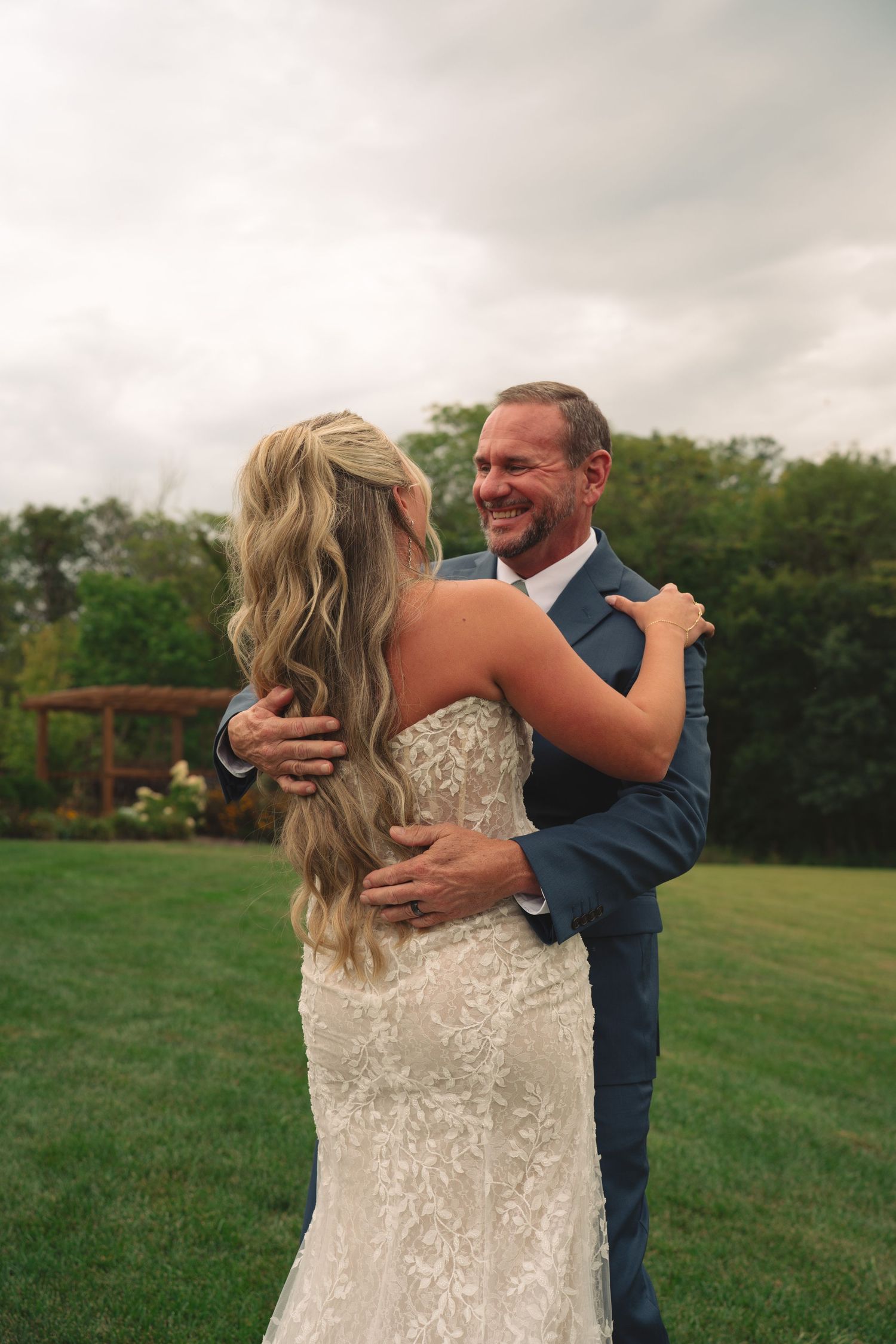 Couple sharing a joyful moment together in an outdoor garden setting.