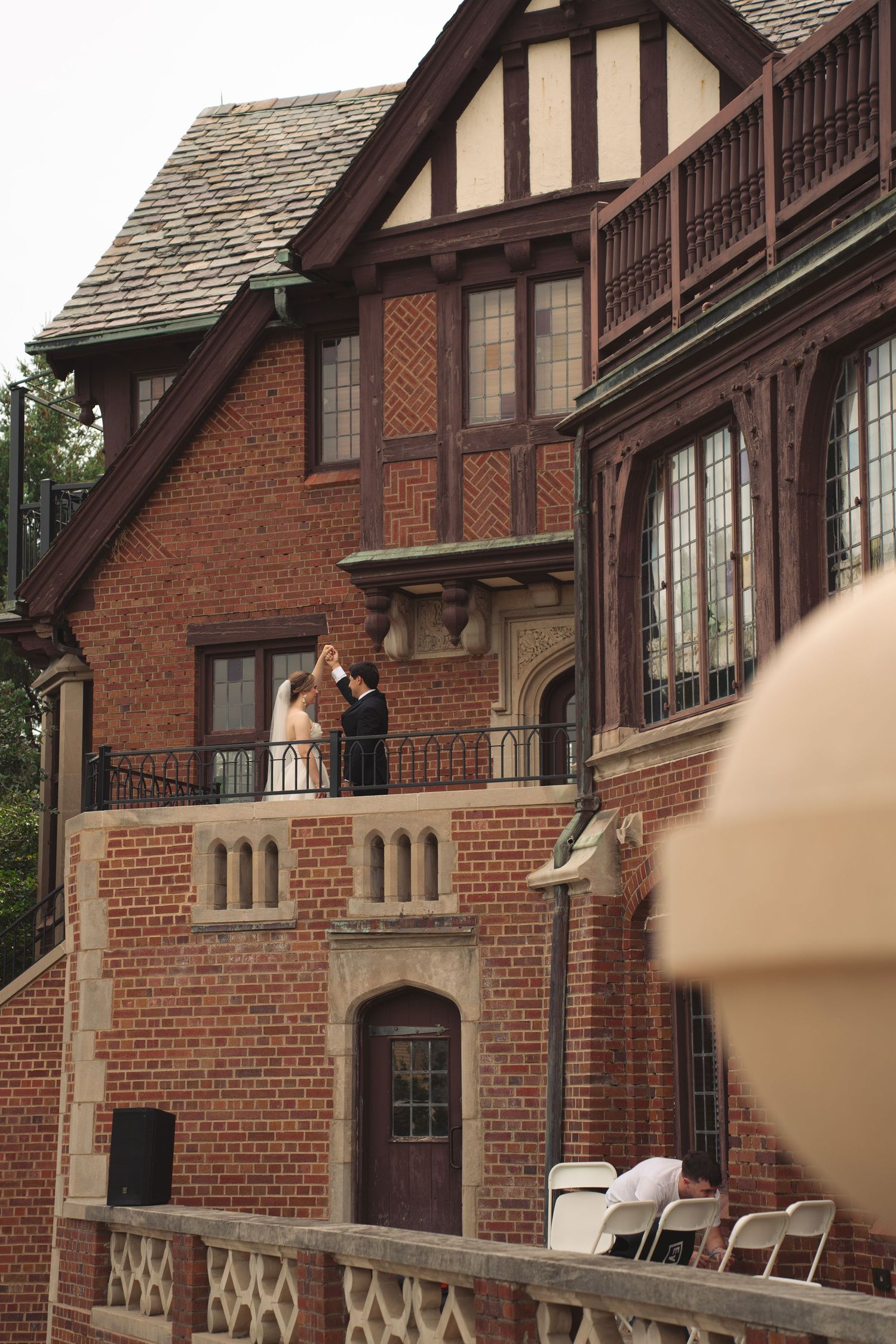 Tudor-style brick mansion provides elegant backdrop for wedding photography.