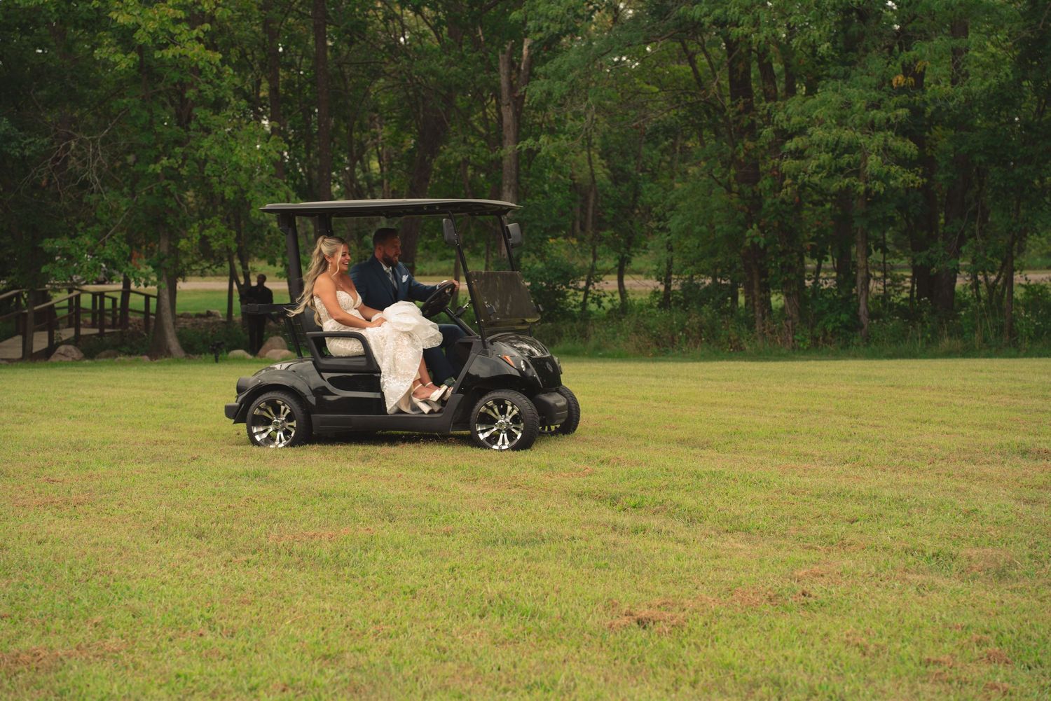 Wedding venue grounds with golf cart and trees in natural outdoor setting.