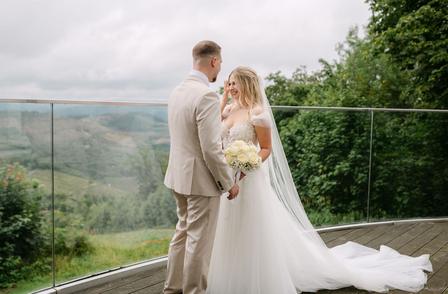 Wedding couple sharing an intimate moment on a scenic mountain overlook.