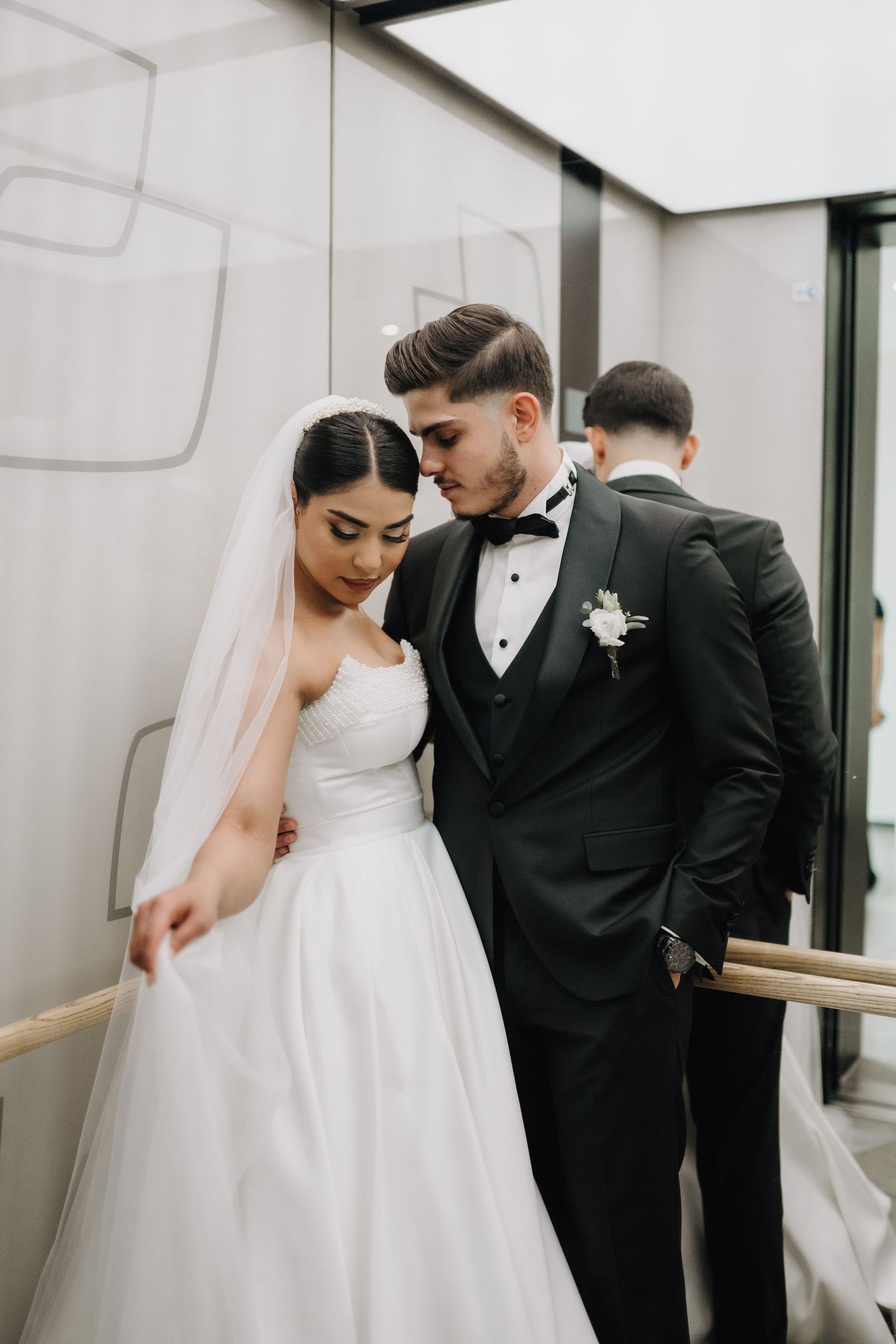Romantic black and white wedding portraits showcase elegant bride and groom in modern setting.