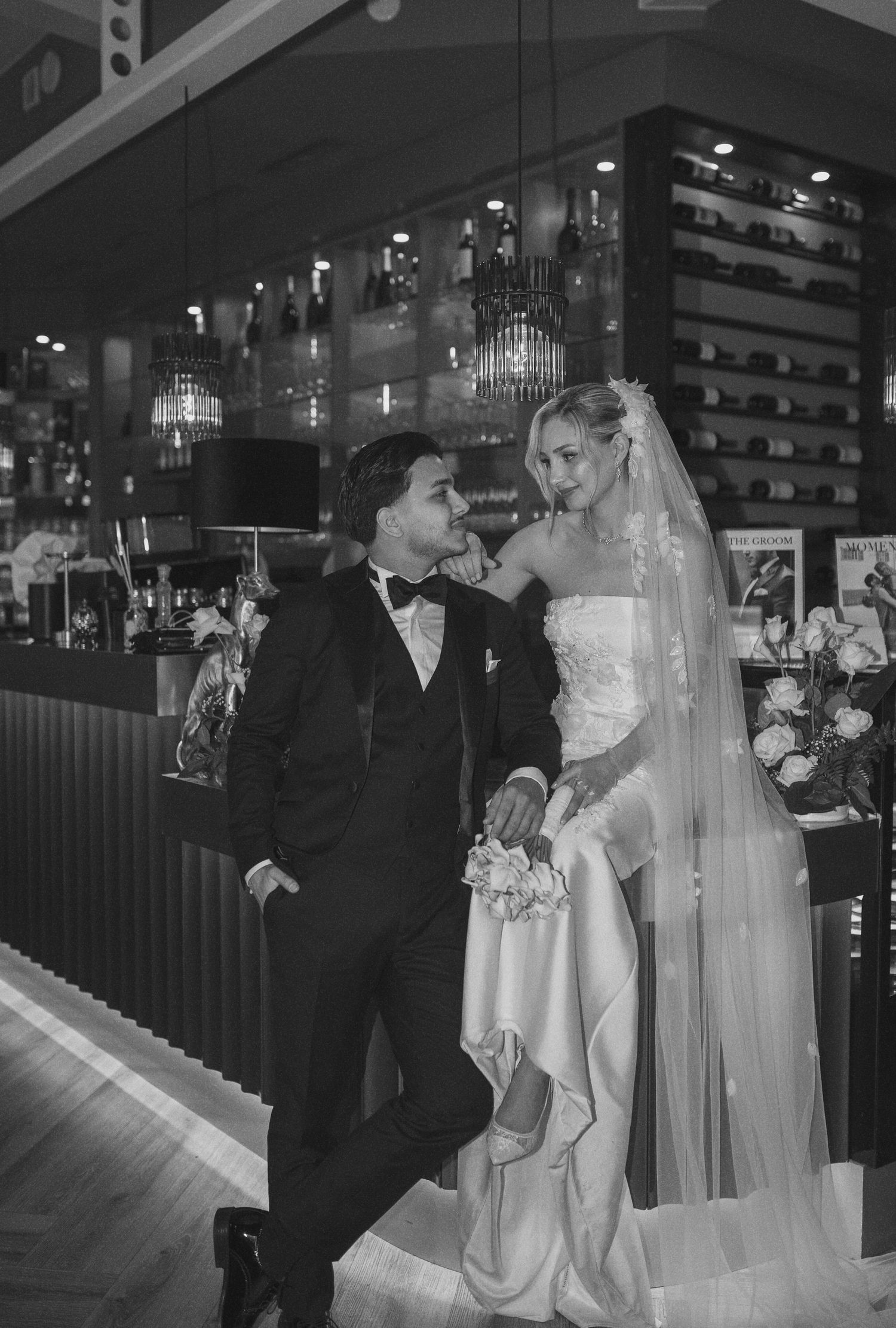 Romantic wedding sequence captured in a dark, atmospheric restaurant setting.