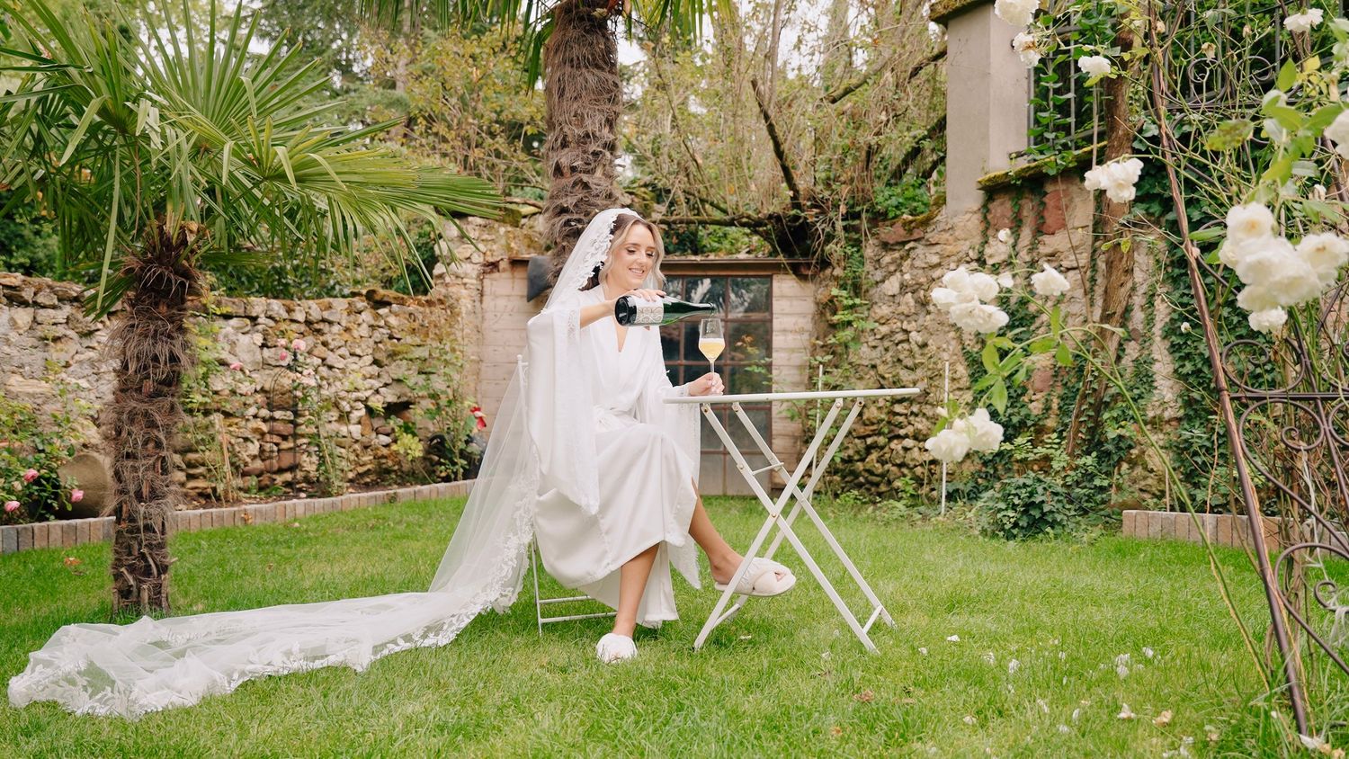Garden wedding setting with scattered petals on grass and decorative elements.