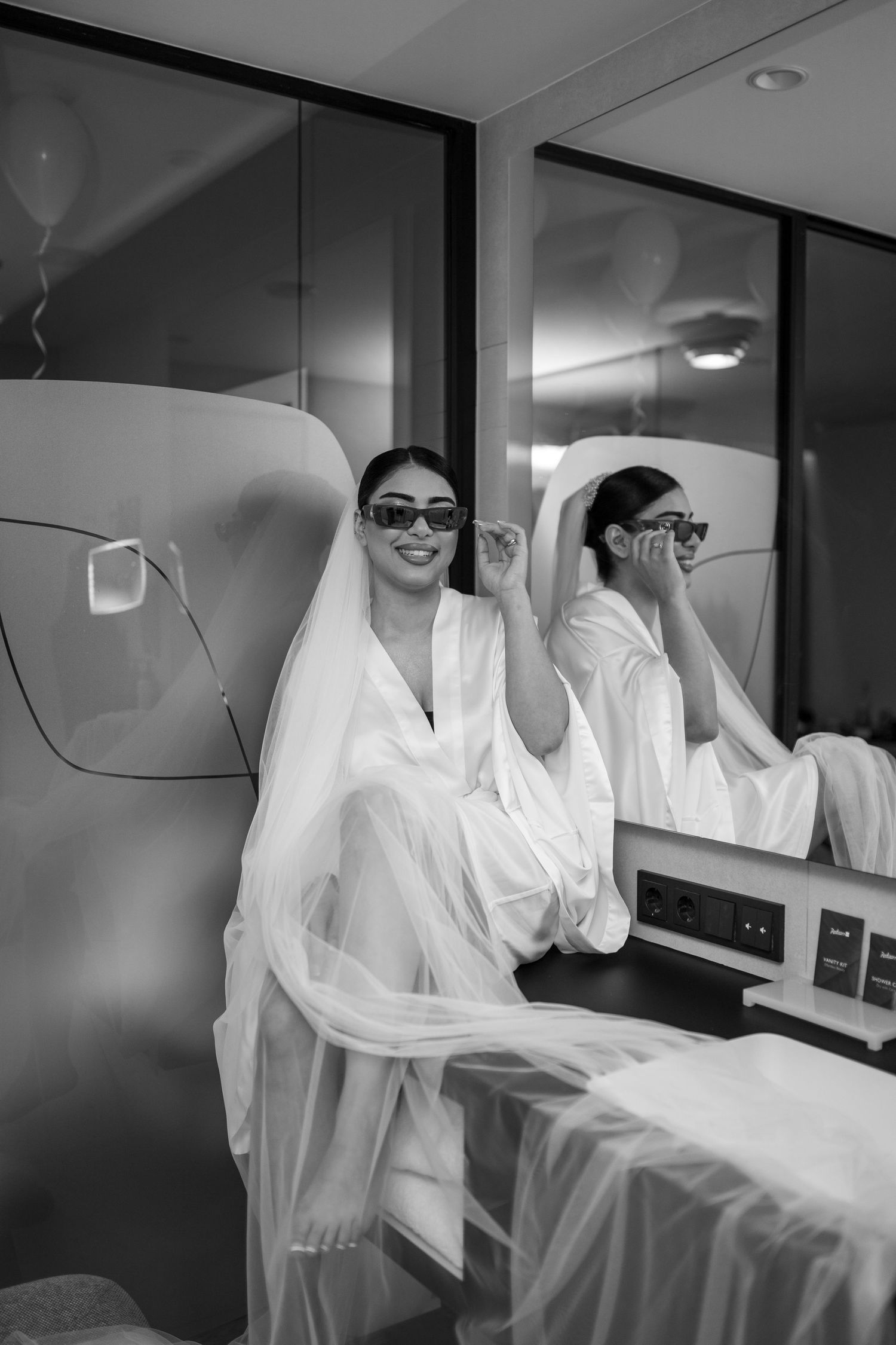 Black and white photos capture candid moments during wedding morning preparations.