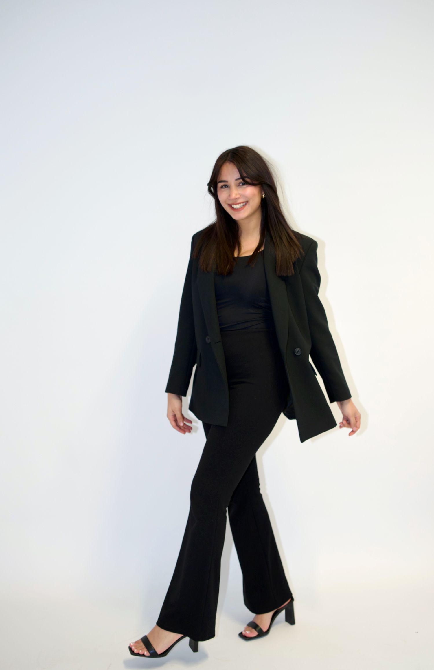 Fashion photo series of a woman in black business attire against white background.