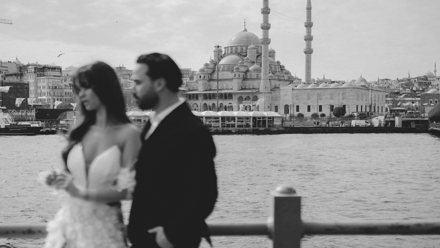 Wedding photo with Istanbul's iconic mosque silhouette across the Bosphorus.