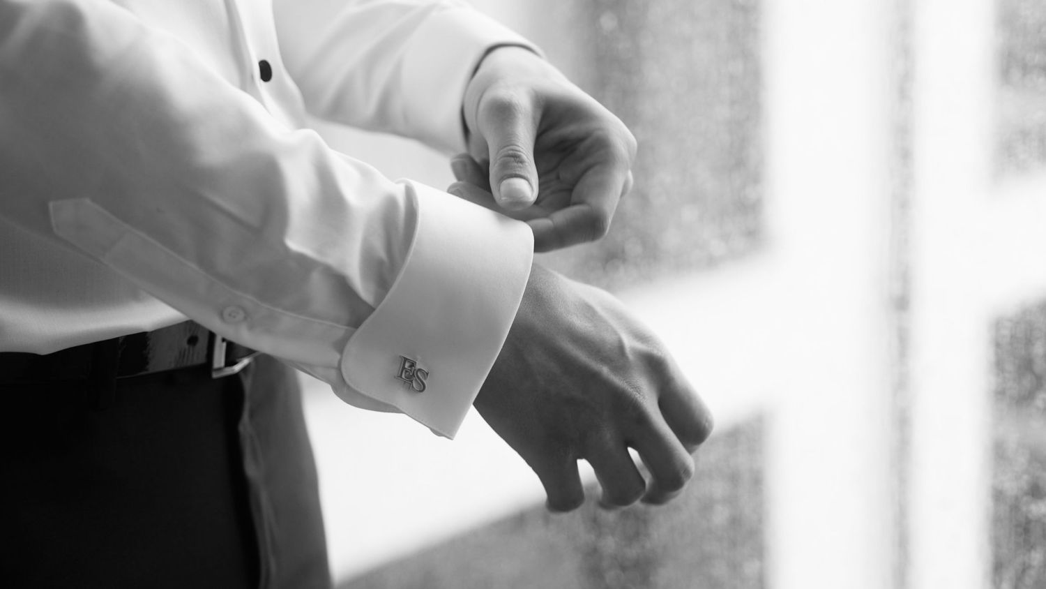 Detail shots of formal white shirt cuffs and buttons in black and white.