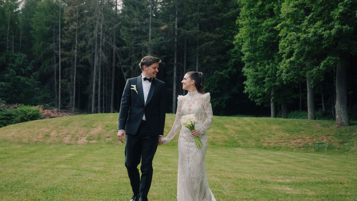 Romantic wedding sequence photographed in lush green outdoor setting.