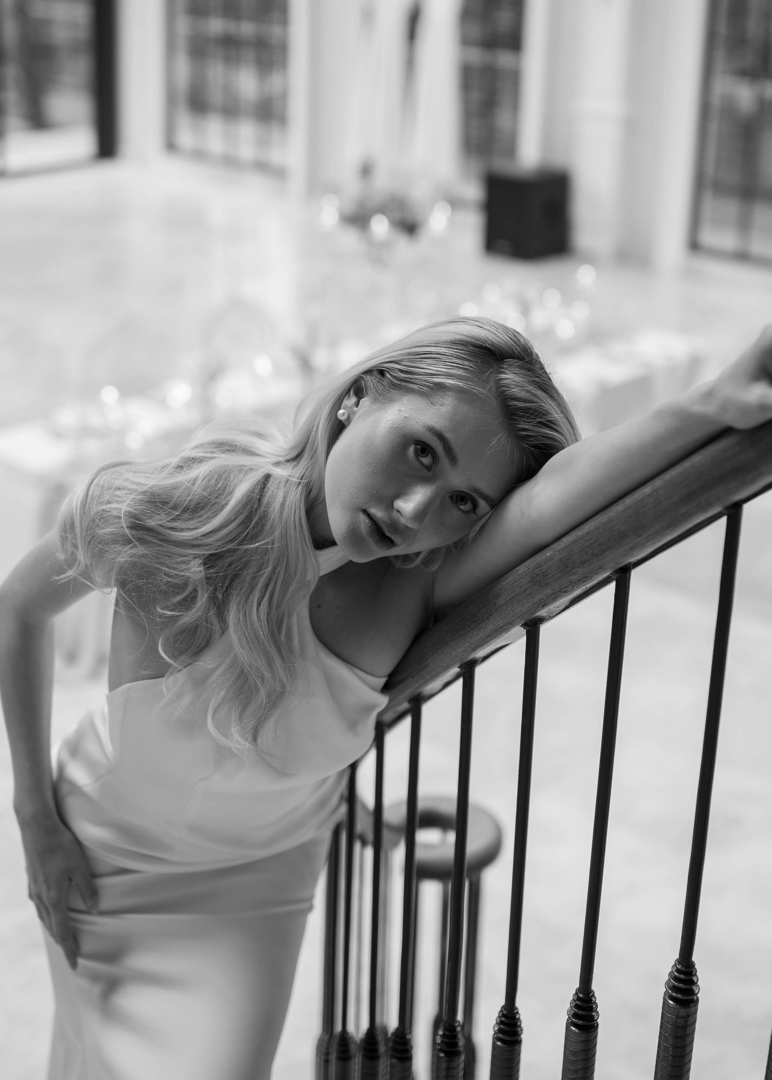Artistic bridal portraits captured against iron railings in dramatic black and white.