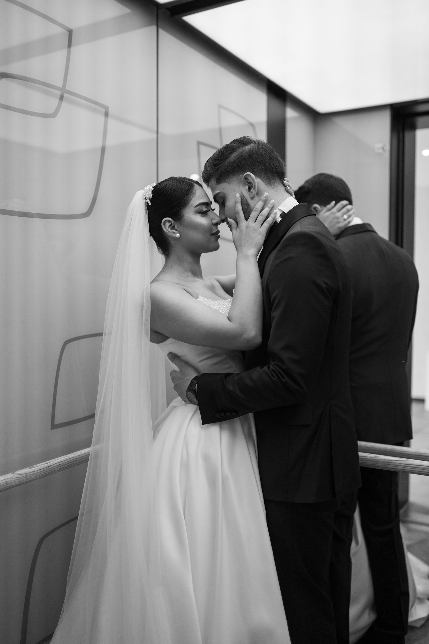Intimate black and white wedding portraits capture tender moments between newlyweds.