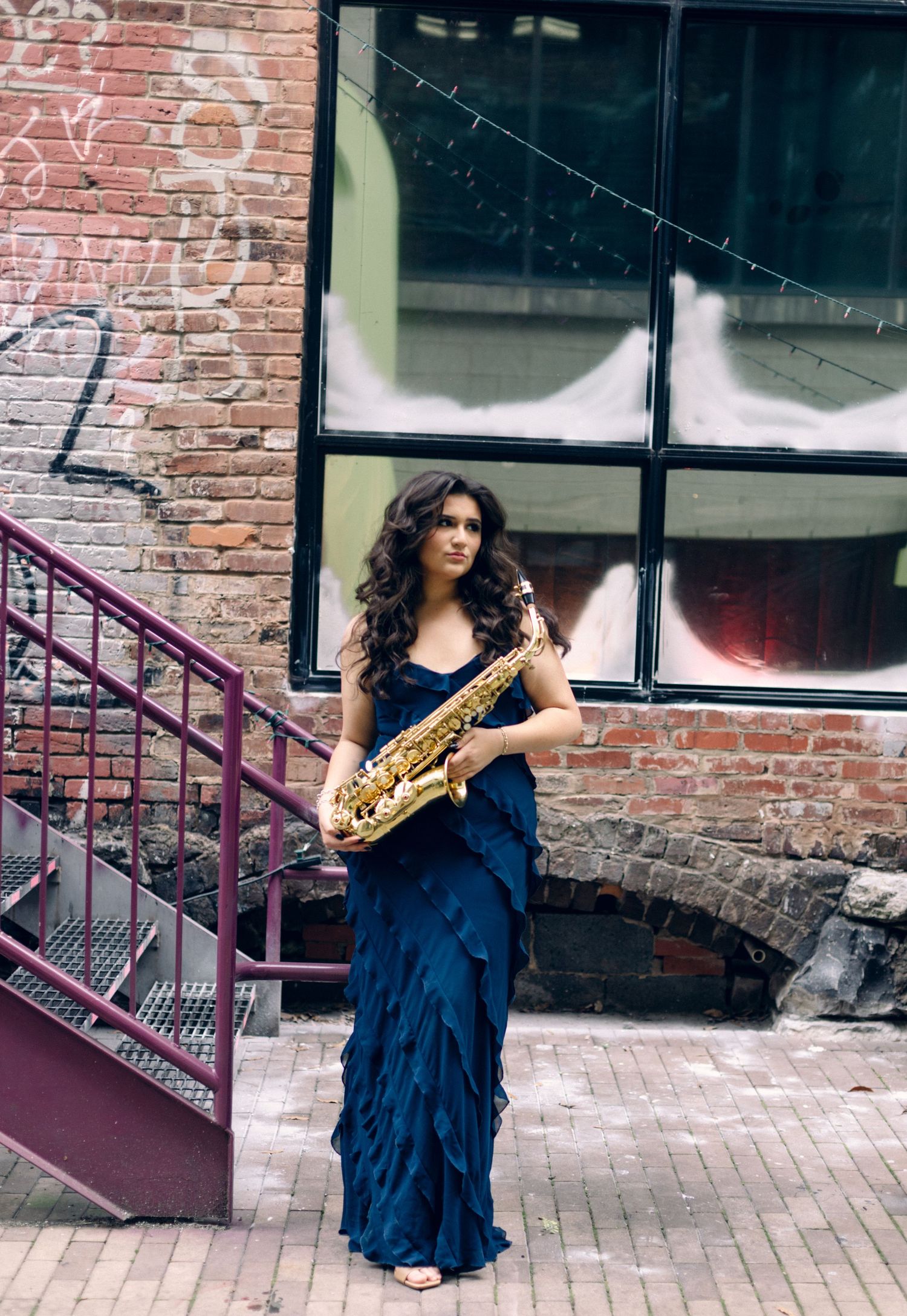 Senior Portrait with music instrument in downtown Chattanooga alley.
