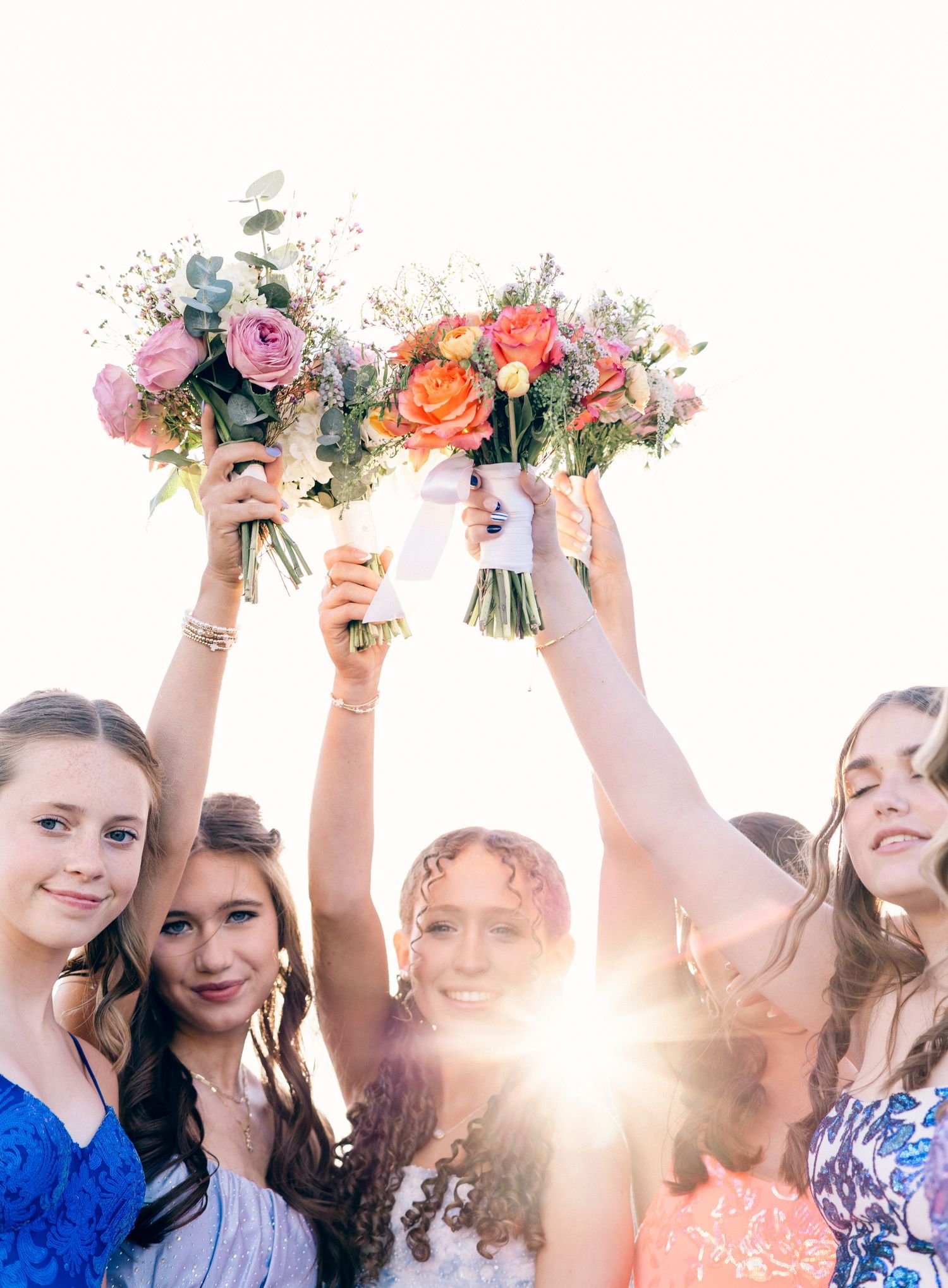 Chattanooga Senior Prom Friends with bouquets in the air.