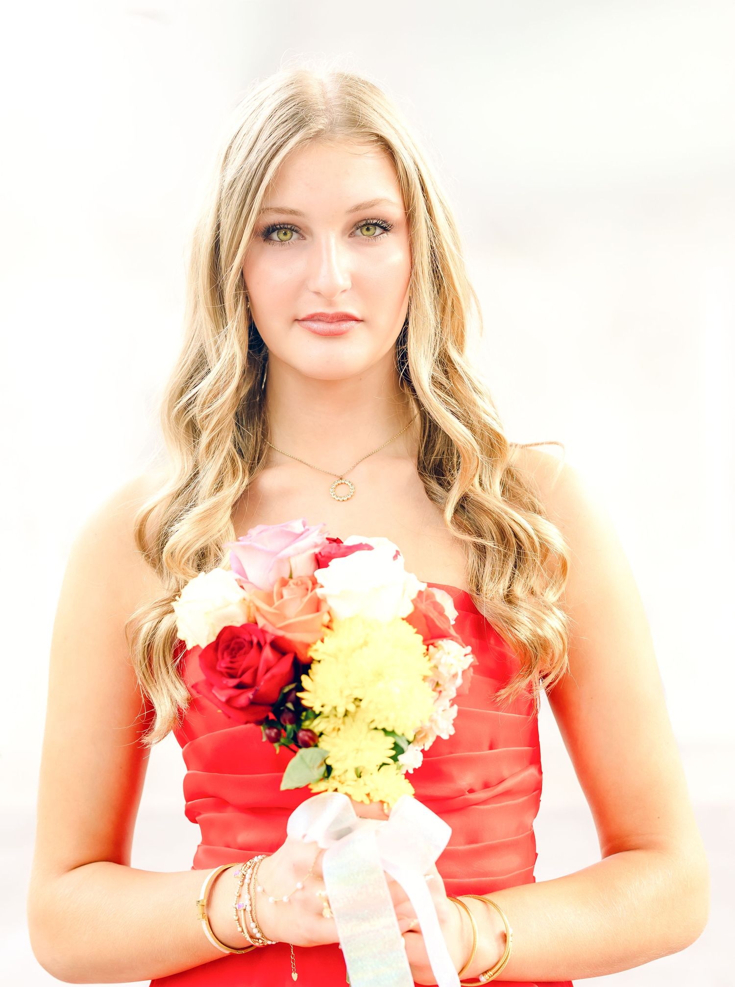 Chattanooga SeniorPortrait of a Blonde Girl holding flowers in red prom dress.