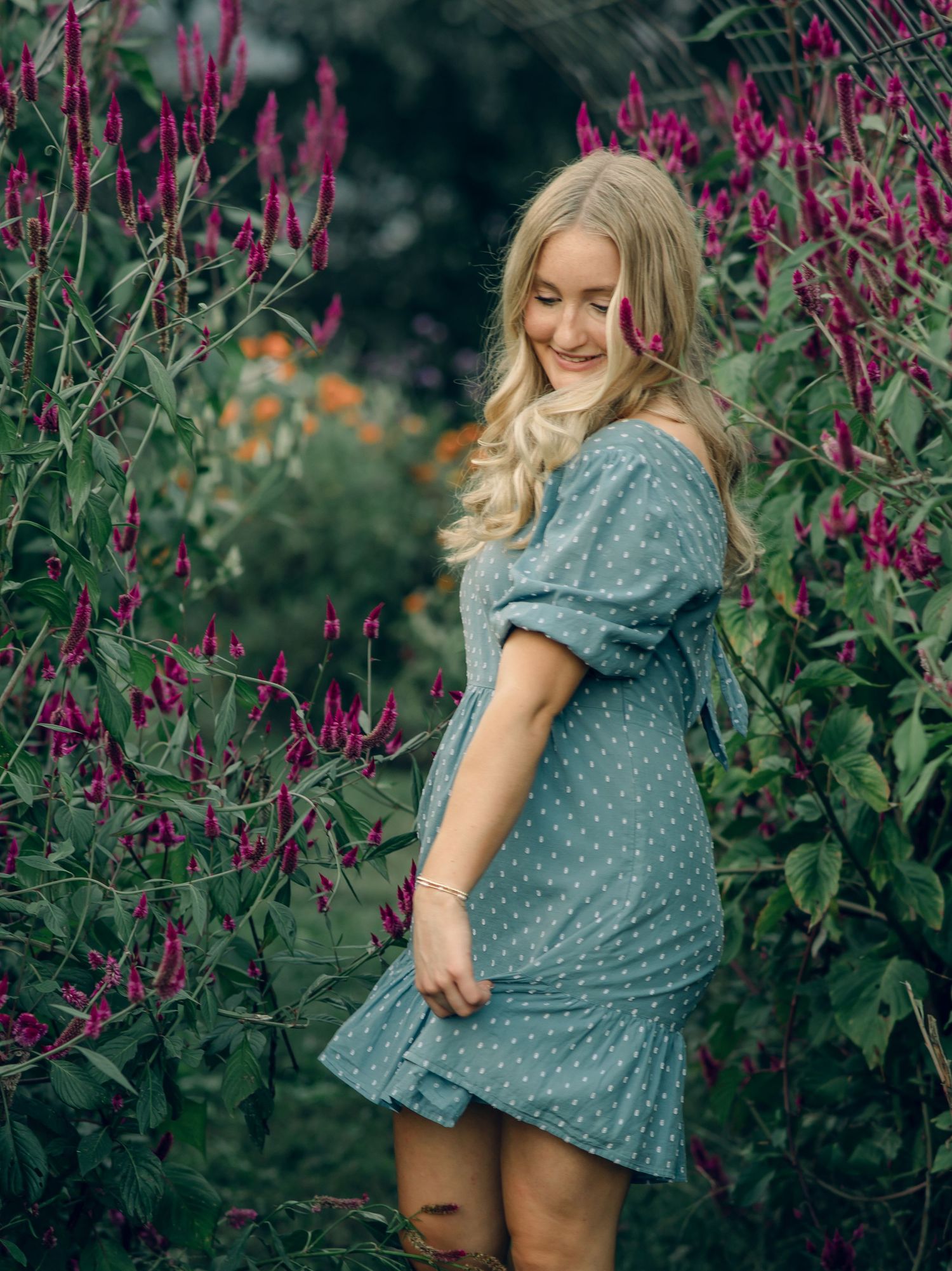 Senior twirling in her dress at the flower farm.