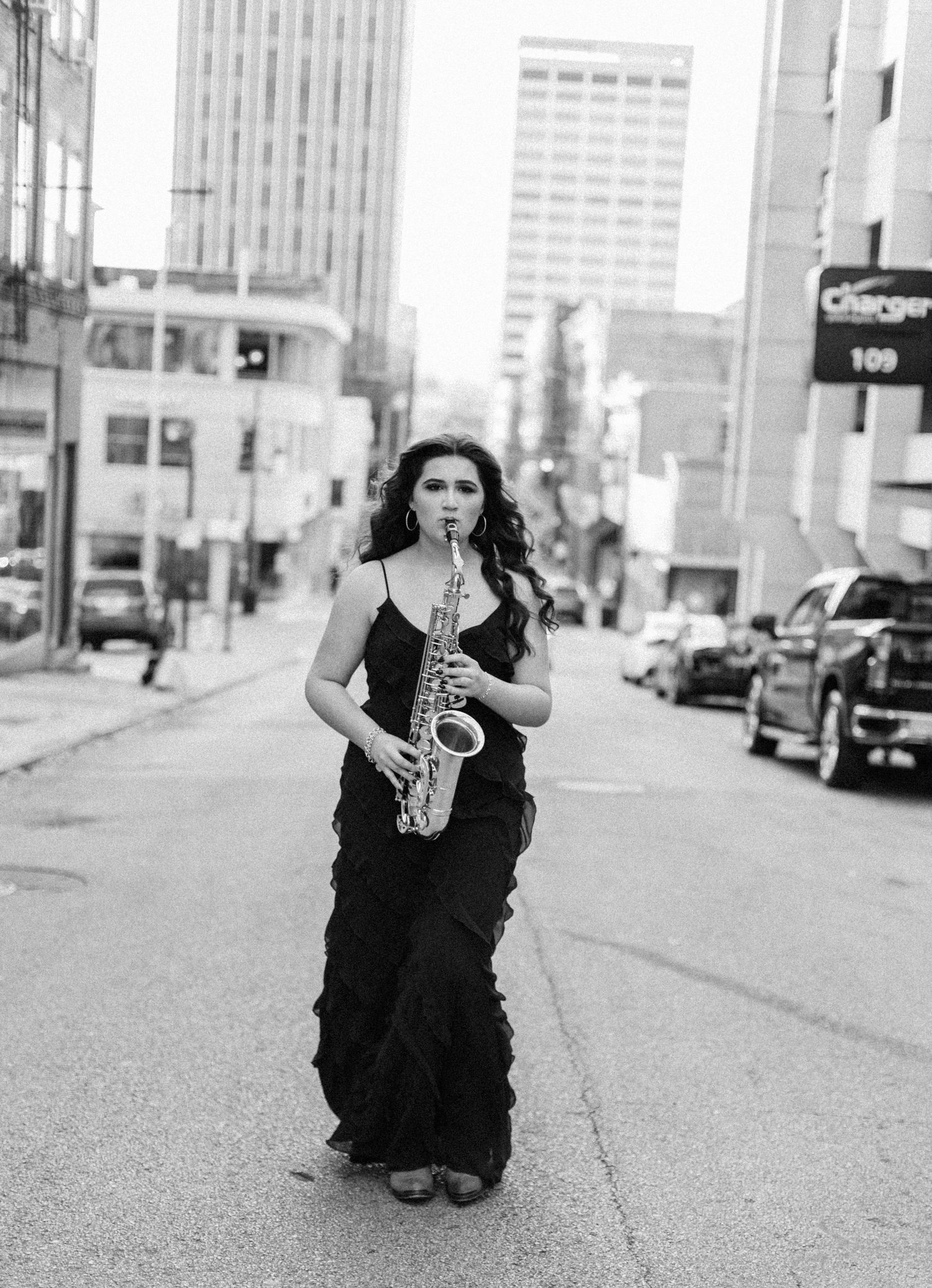 Urban street photography in black dress and saxophone in black and white.