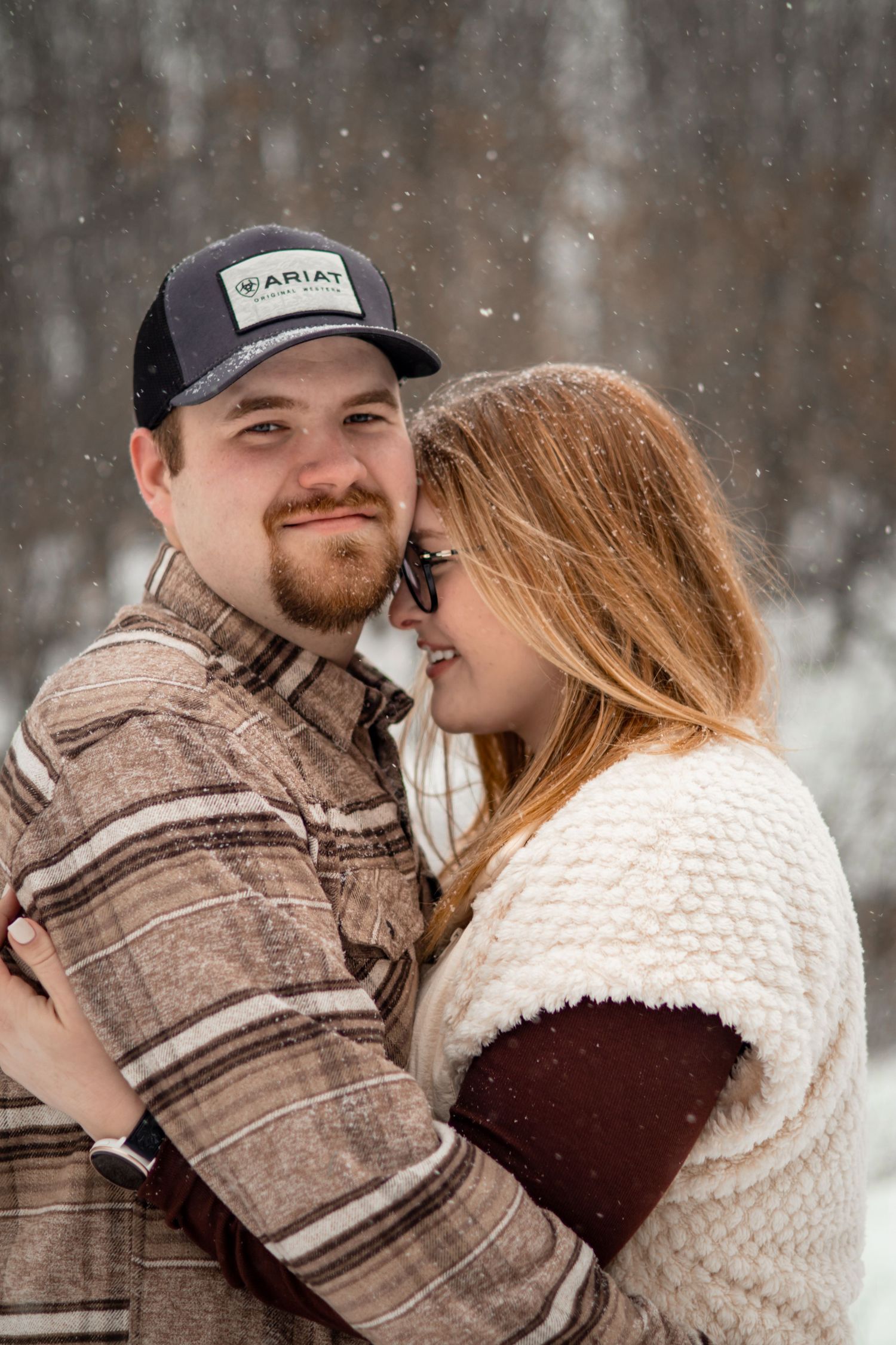 A tender moment captured between a couple during their winter engagement session.