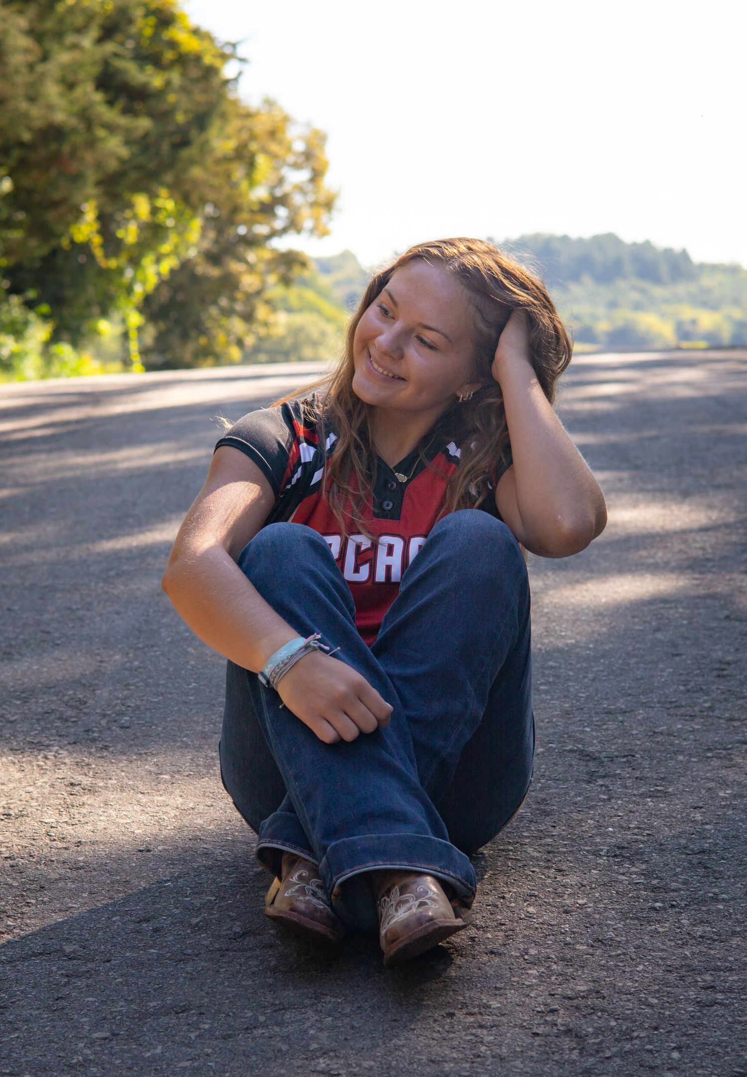 Casual outdoor portrait session on dirt path during sunset.
