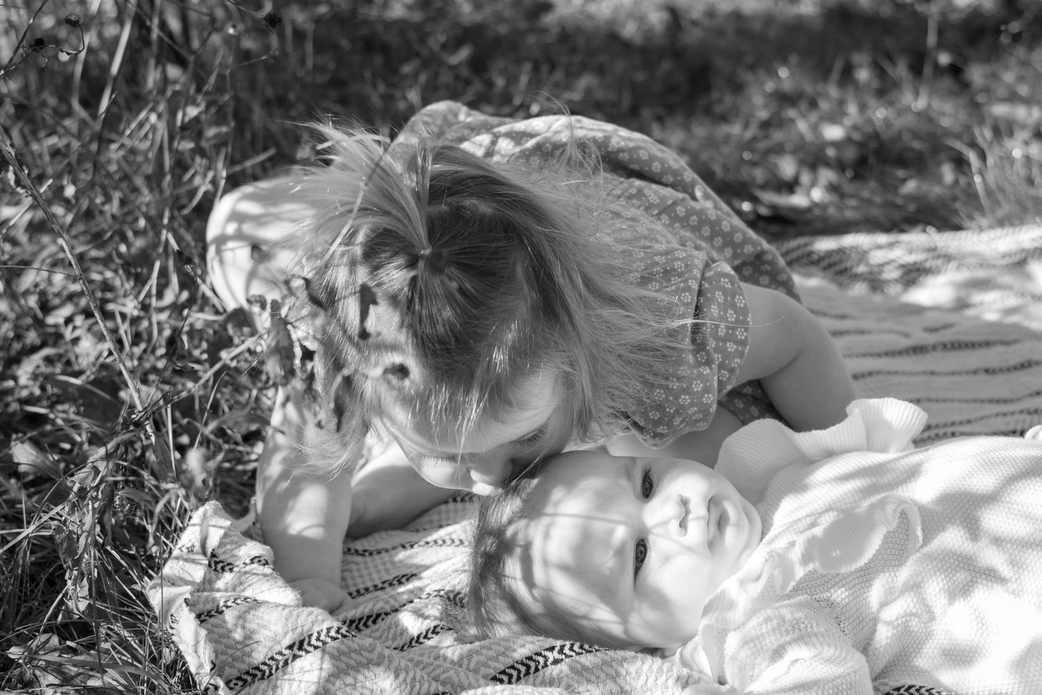 Black and white portrait series showing tender moments and expressions in natural lighting.