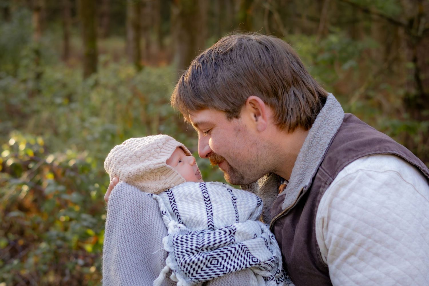 A gentle moment shared between parent and infant wrapped in cozy knitwear.